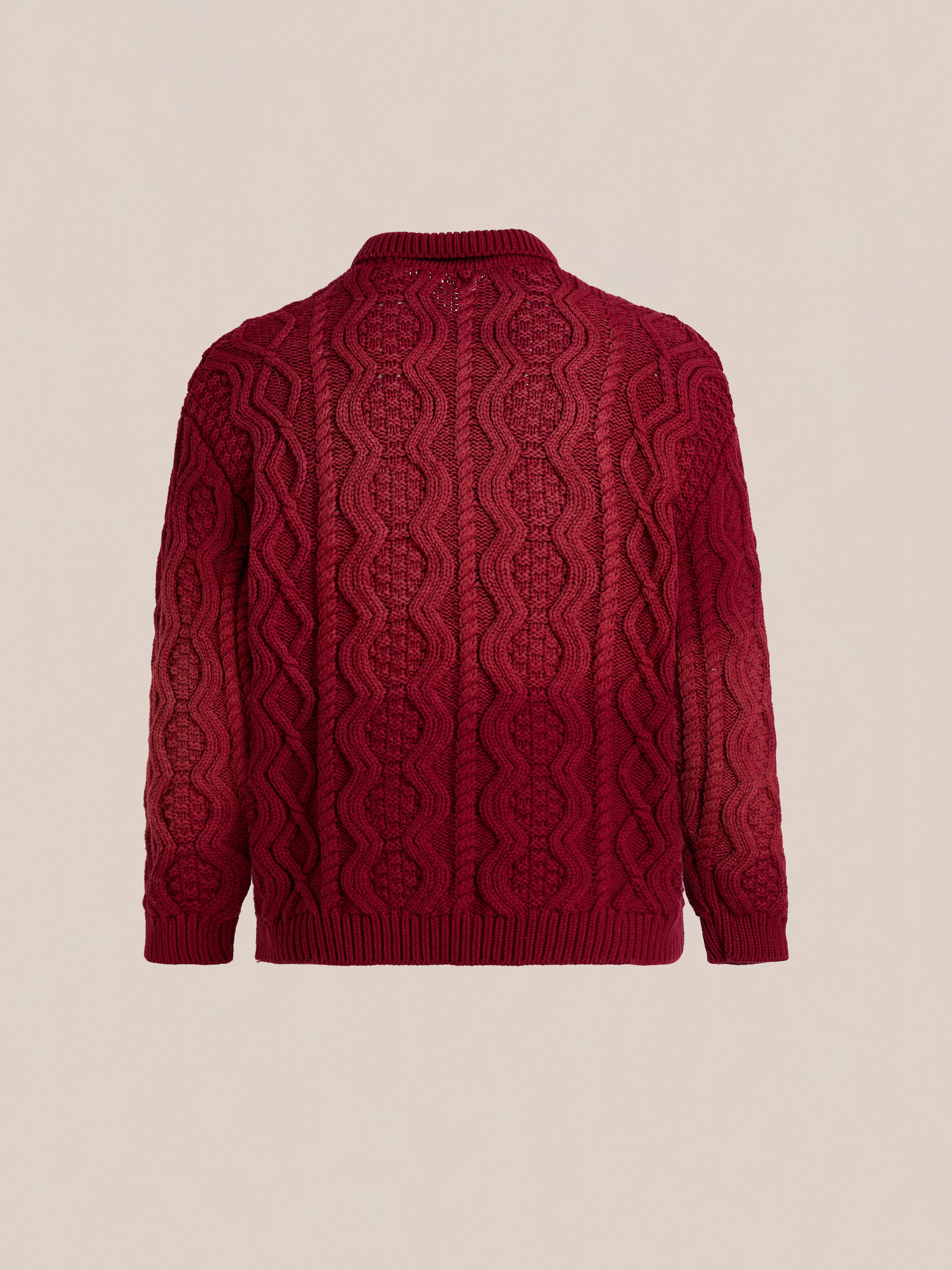 Back view of FOUND's Cable Knit Buttoned Cardigan in red, featuring chunky cable knit, ribbed hem, cuffs, and collar, shown against a plain beige background.