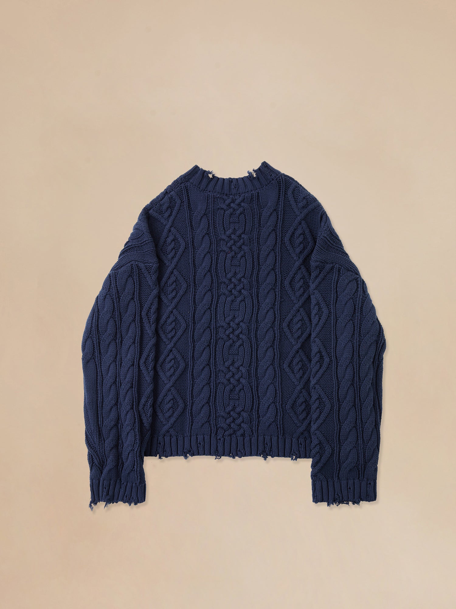 A Found Astral Distressed Cable Knit Sweater in a blue color.