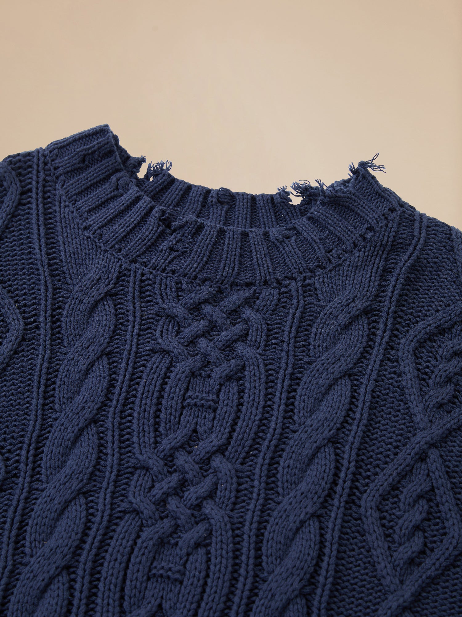 A close up of a Found Astral Distressed Cable Knit Sweater in navy - gallery image 5.