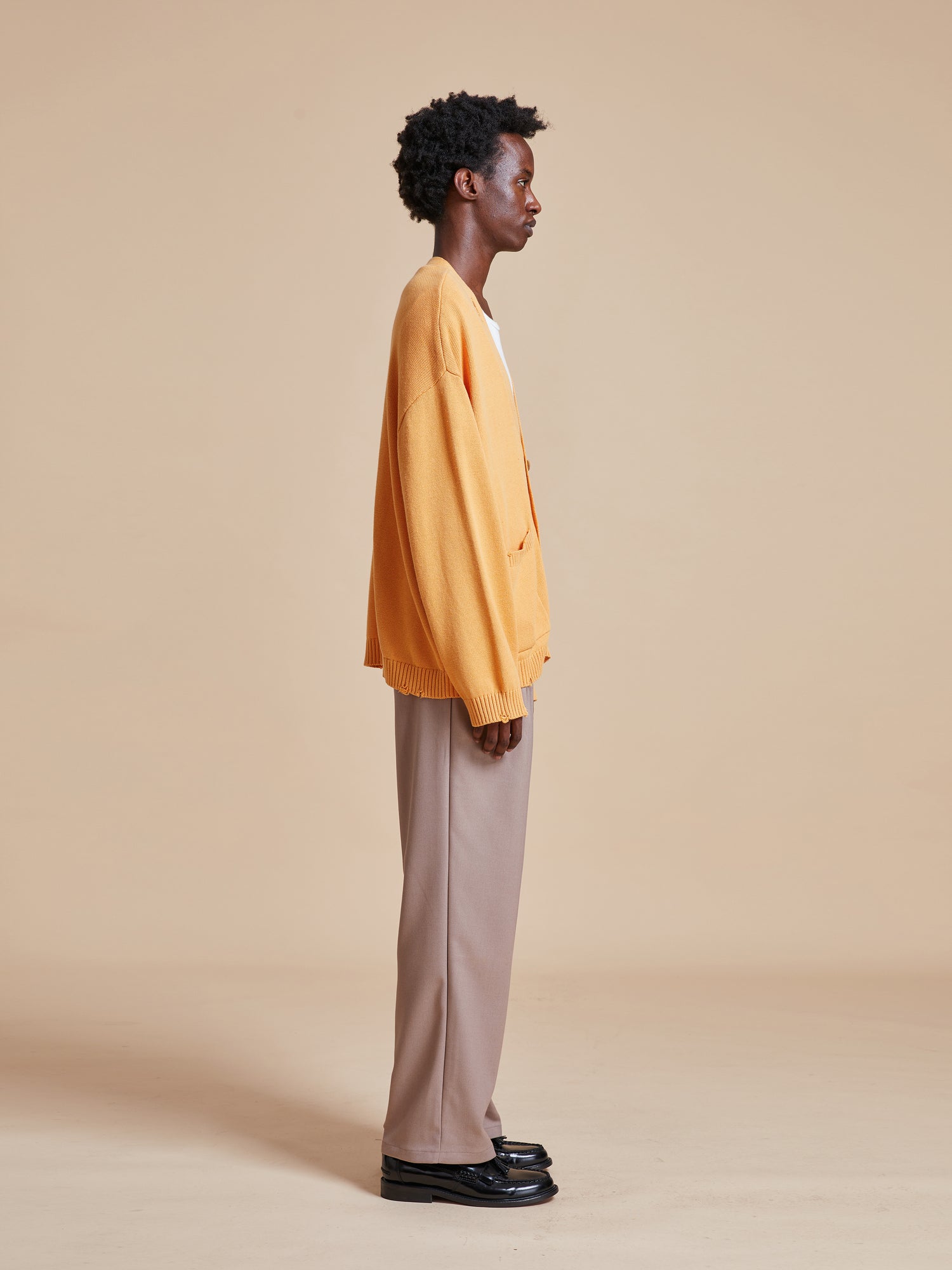 WornOnTV: Devi's orange floral cardigan and brown corduroy pants