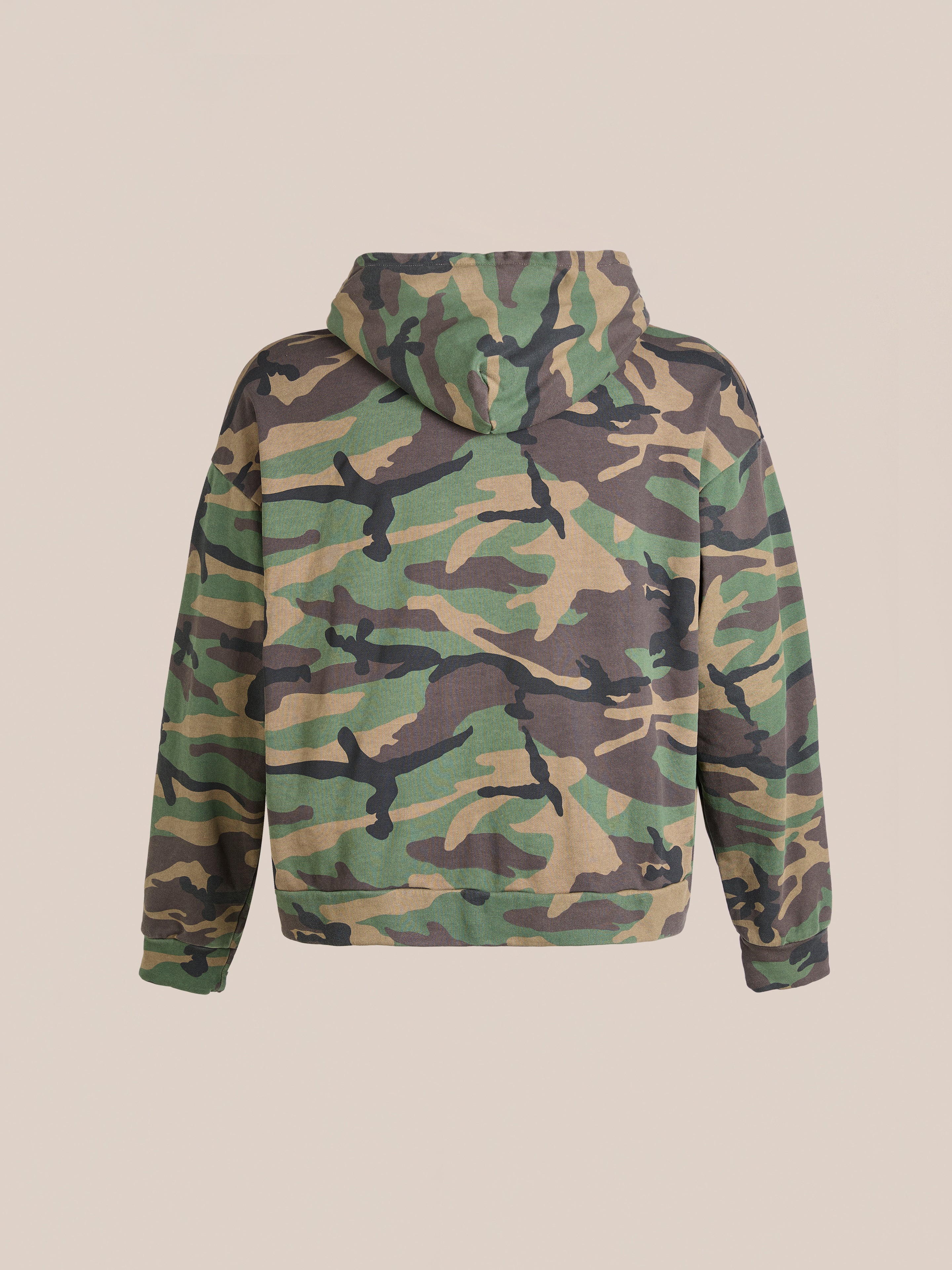 The Washed Camouflage Zip Hoodie by FOUND, made from French terry cotton, is displayed against a beige background.