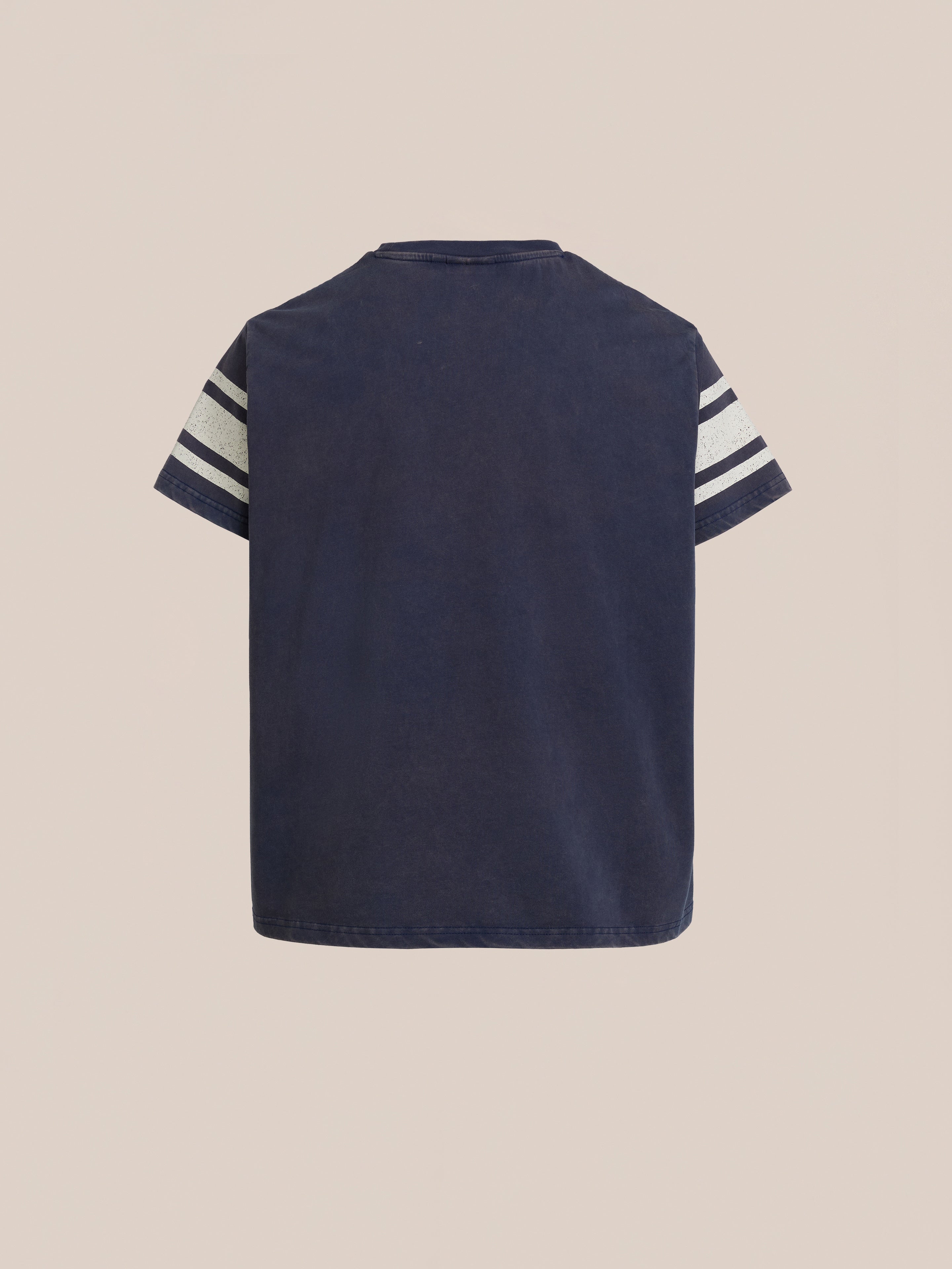 The Collegiate Crest Tee by FOUND is a unisex navy blue t-shirt with white double stripes on each sleeve and a plain back, reminiscent of vintage athletic gear, displayed against a light background.