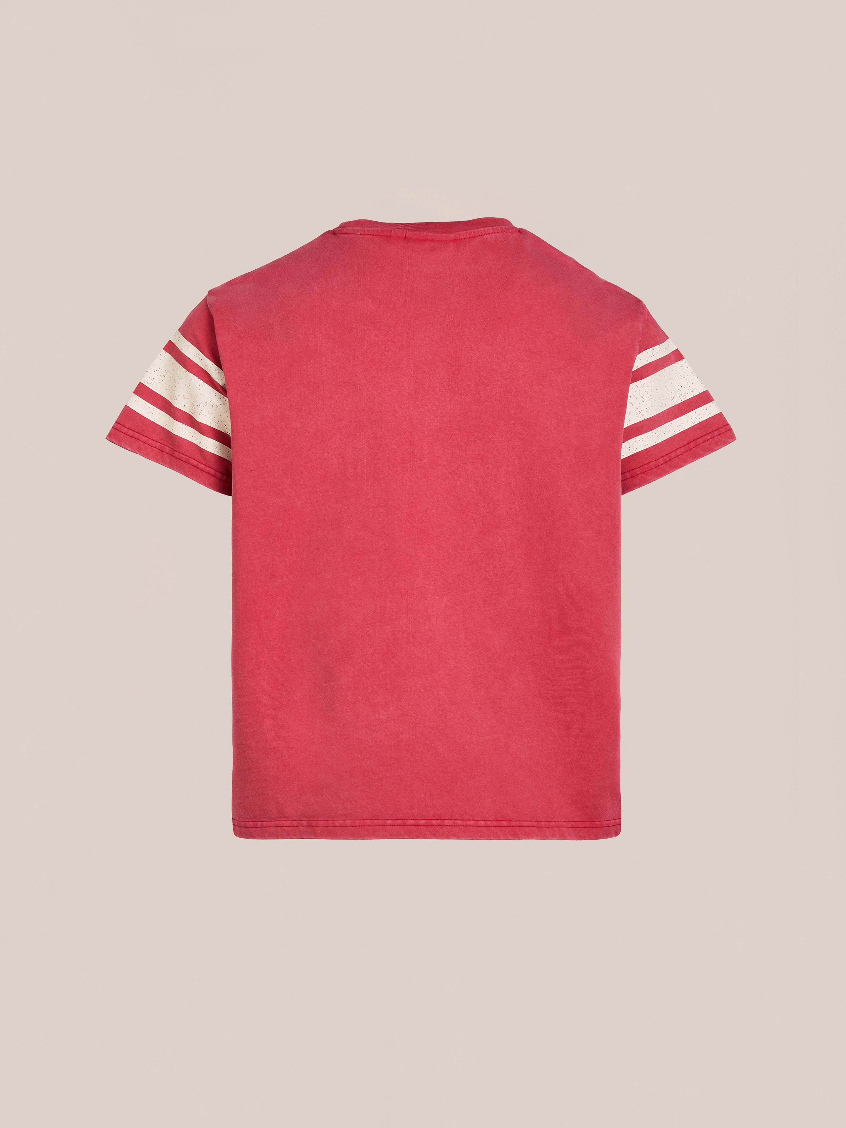 The FOUND Collegiate Crest Tee combines vintage athletic gear with modern style, featuring red short sleeves and classic white and red striped accents. Its unisex relaxed fit makes it versatile, elegantly displayed against a beige background.