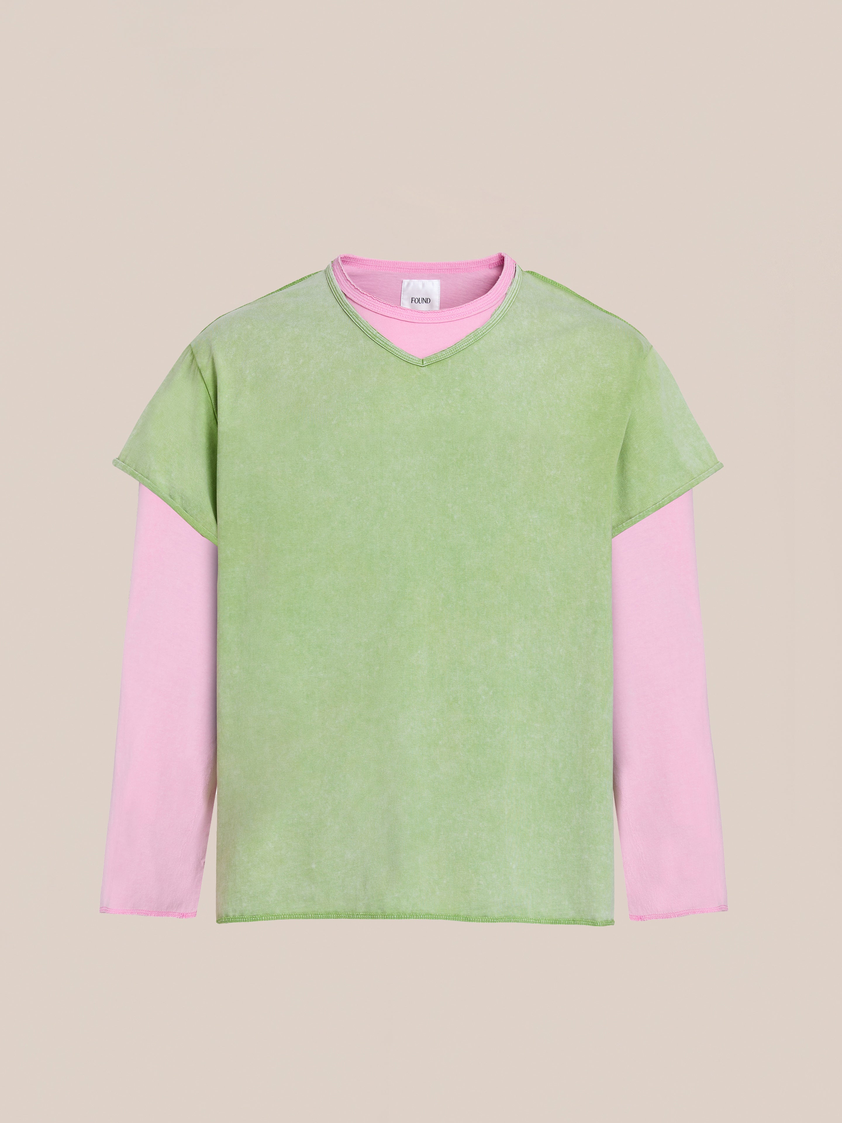 FOUND Double Layer LS Tee: a long-sleeve pink top layered under a short-sleeve green T-shirt with a sunfade wash, shown on a plain beige background.