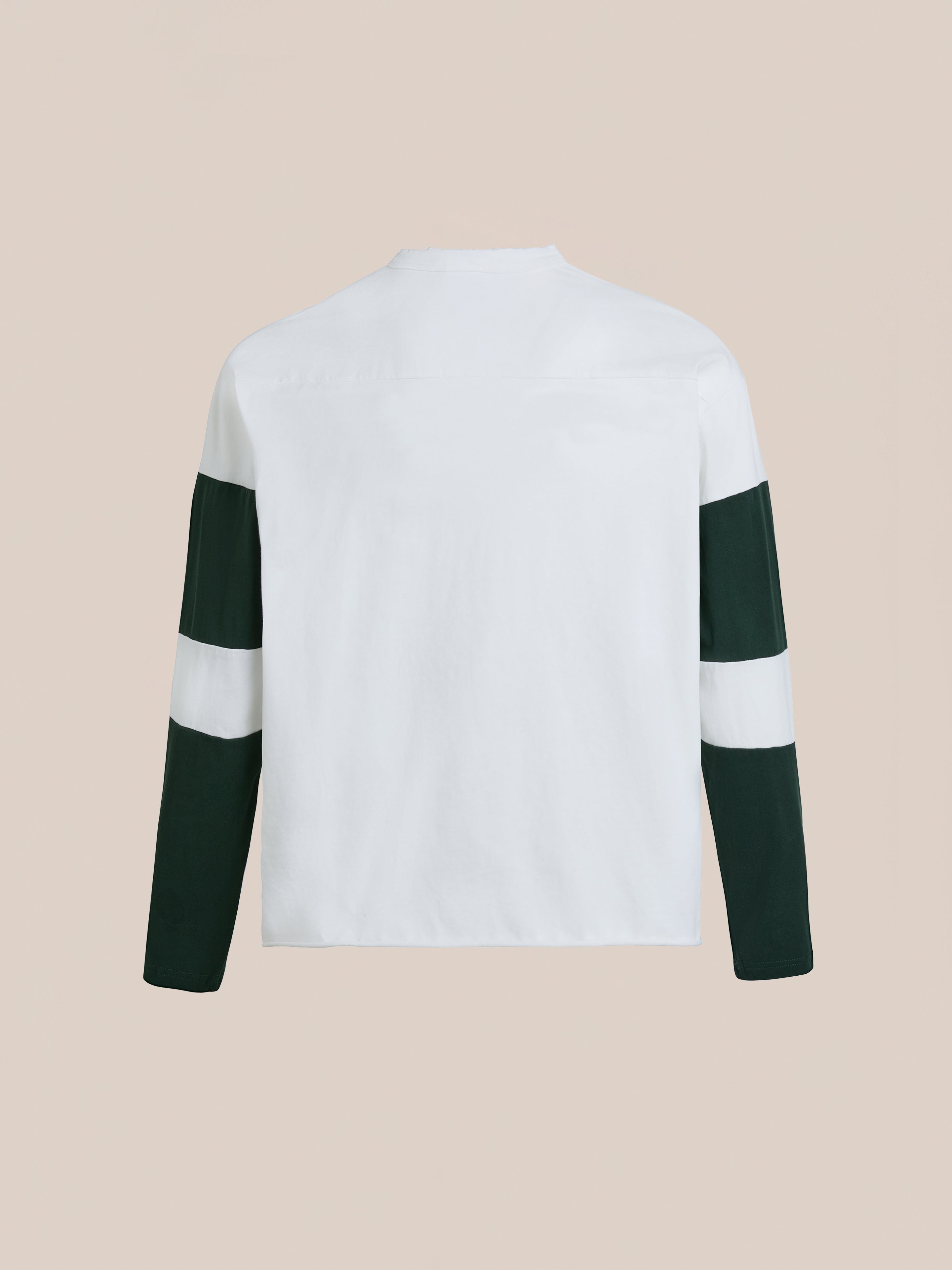 Back view of FOUND's Distressed LS Team Jersey, a relaxed-fit long-sleeve shirt featuring a white upper body with black and white block-striped sleeves, reminiscent of vintage sportswear, set against a neutral background.