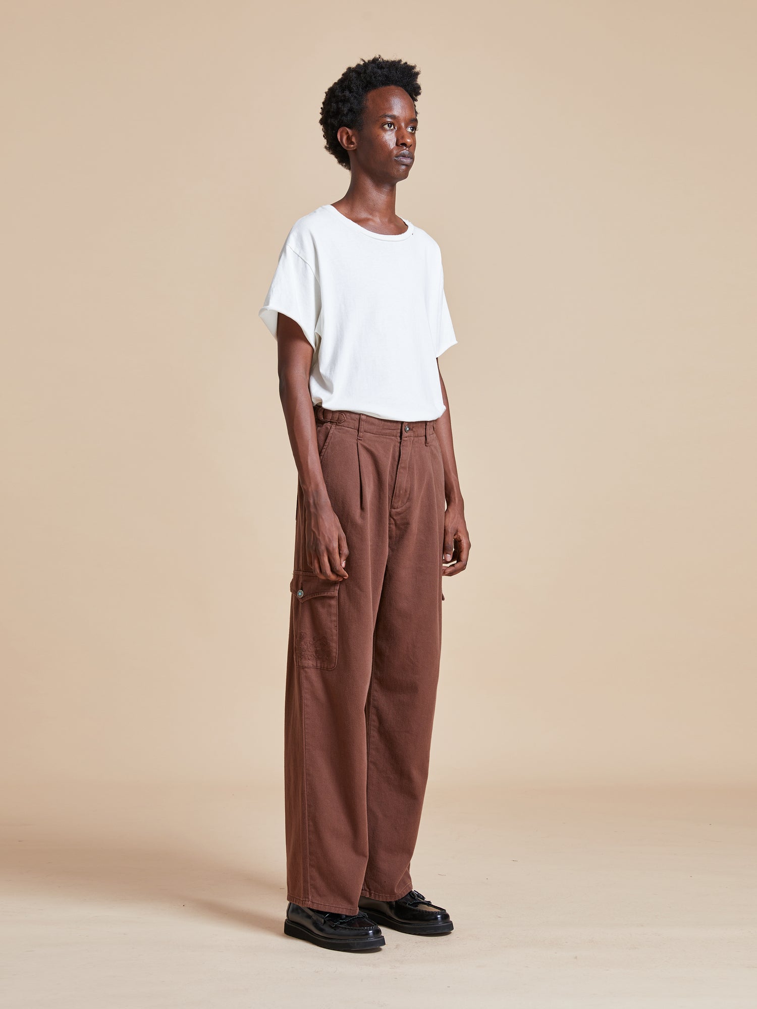 The model is wearing a white t-shirt and Dusky Western Cargo Jeans.