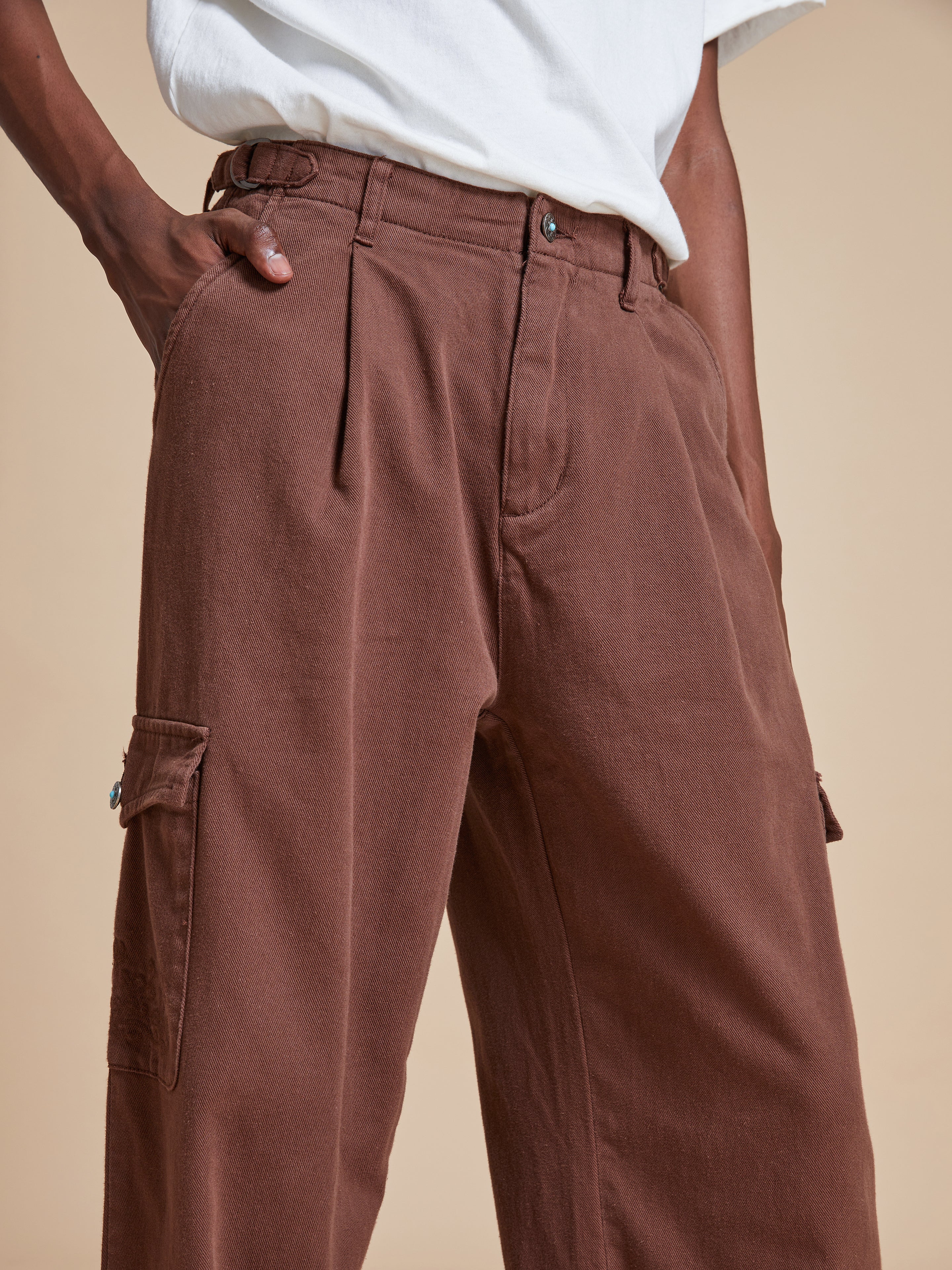 The model is wearing a Dusky Western Cargo Jeans by Found.