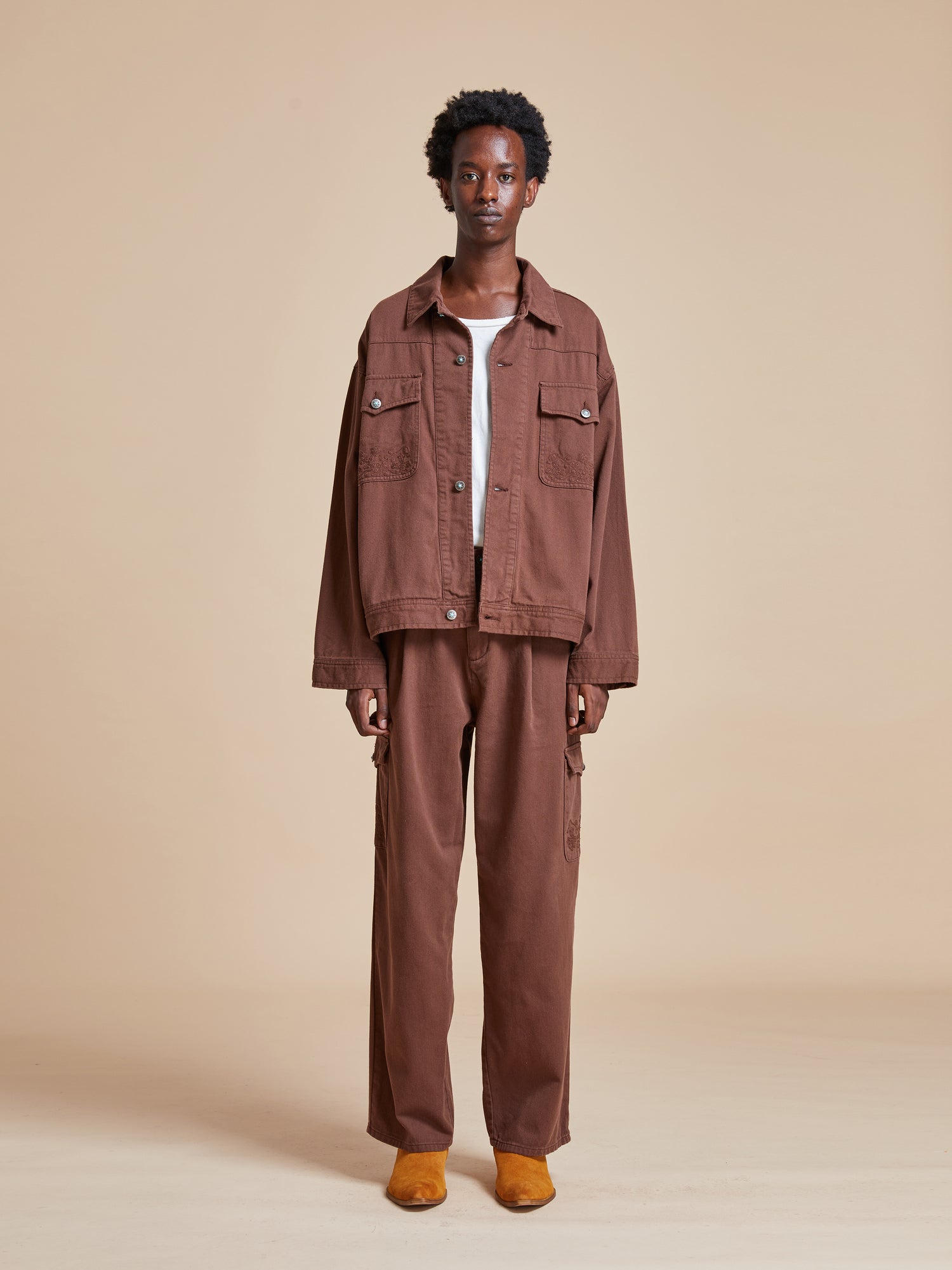 The model is wearing a Found Dusky Western Trucker Jacket and pants.