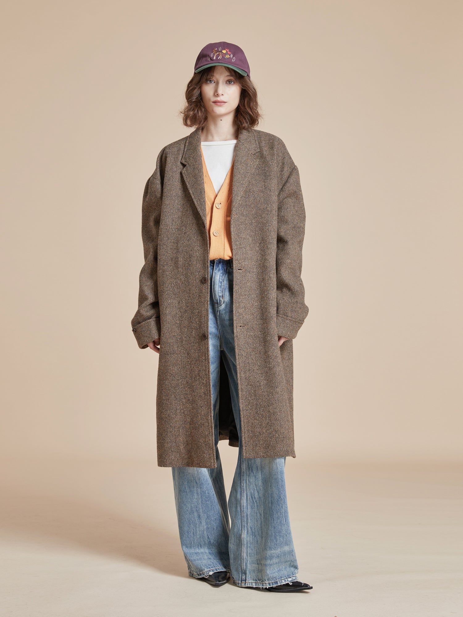 A woman in a warm Elm Tweed Long Top Coat by Found.