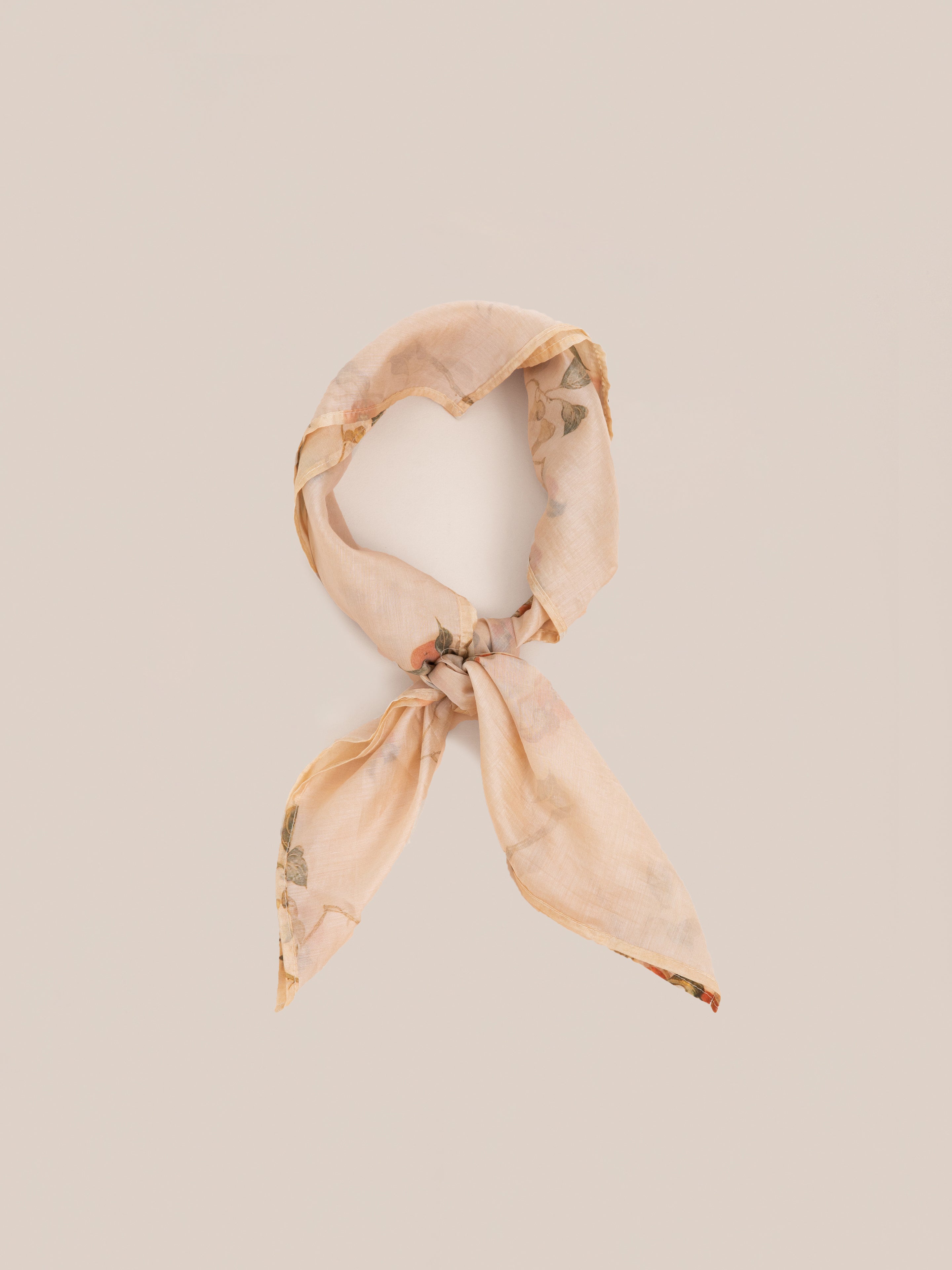 A Roshan Floral Bandana by FOUND is tied in a knot and displayed against a plain background.