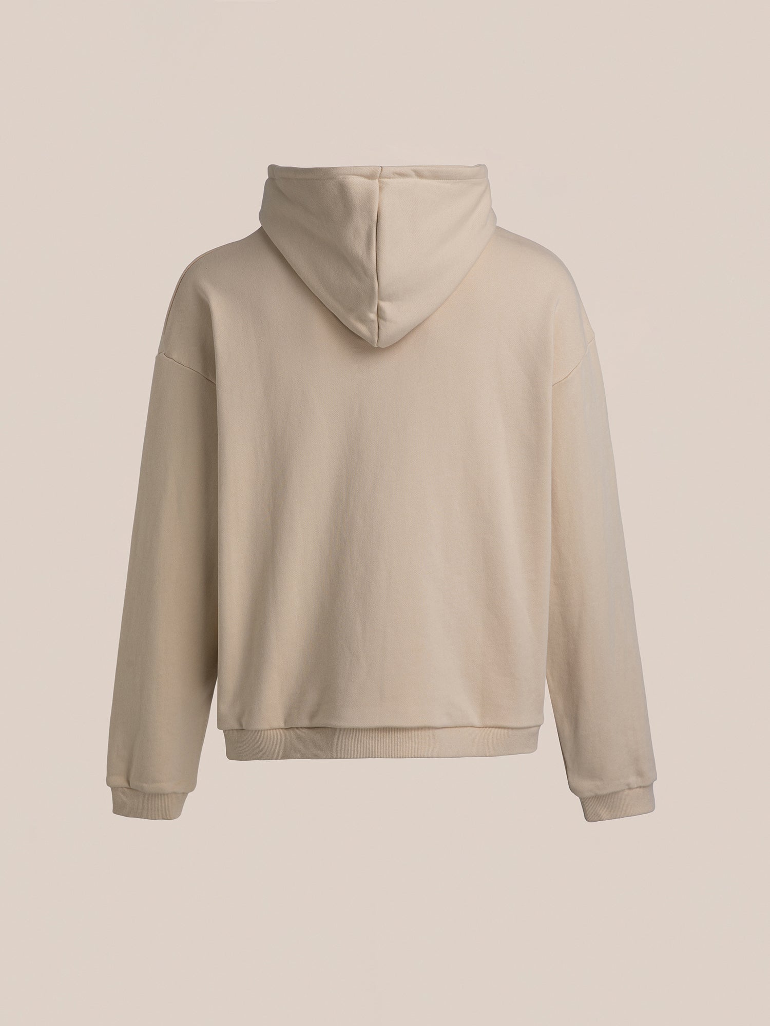 The Horseman Hoodie by FOUND is displayed from the back, showcasing its hood and long sleeves. Embrace the spirit of a cowboy on horseback with this timeless vintage-inspired beige design.