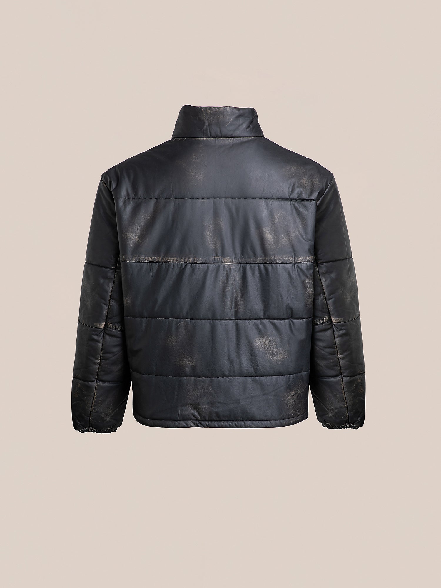 A chic Leather Distressed Puffer Jacket by FOUND features a high collar, long sleeves, and subtle pattern, crafted from ethically sourced materials. Viewed from the back.