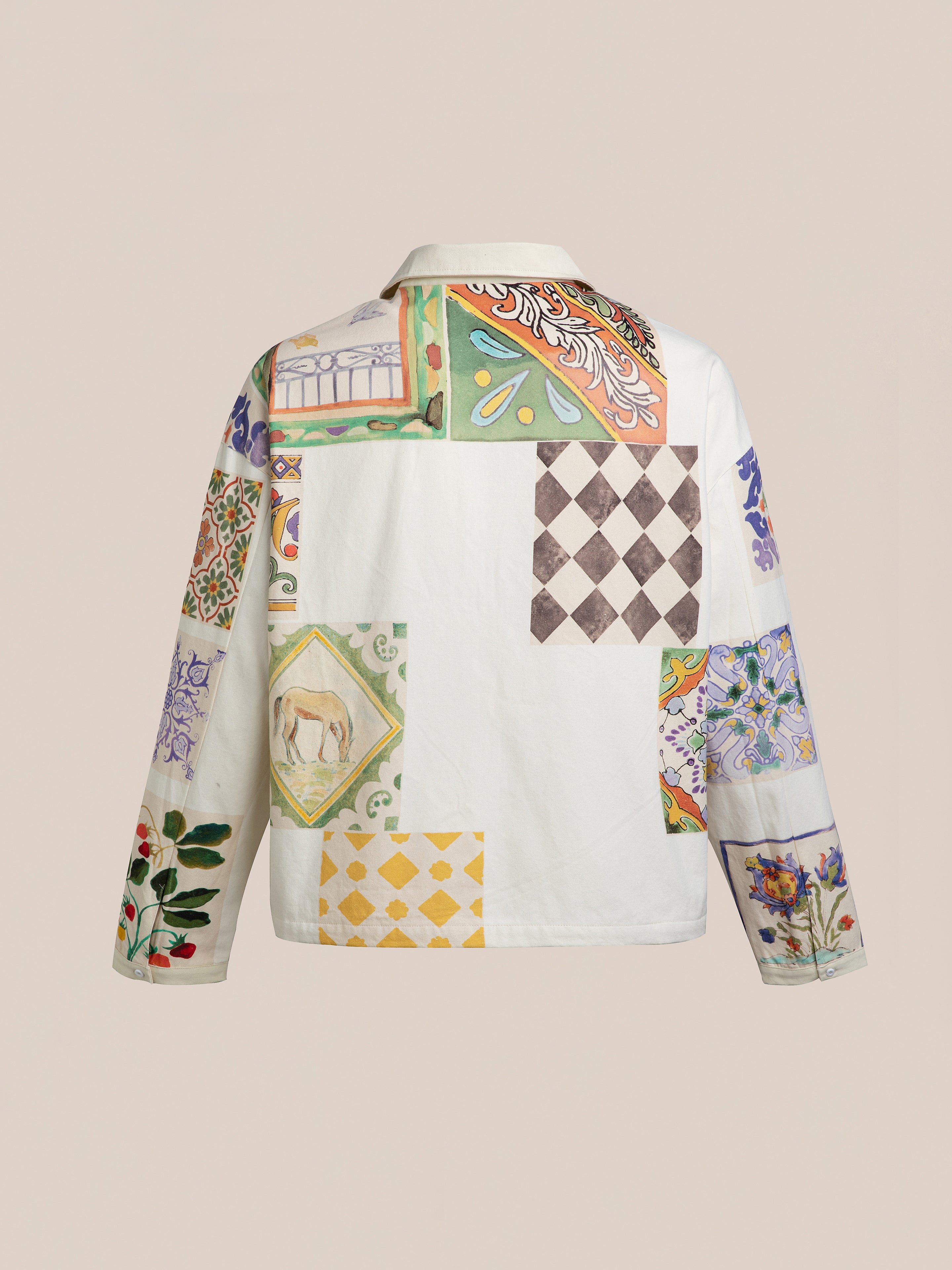 The Mosaic Work Jacket by FOUND showcases a patchwork design with various colorful patterns and illustrations set against a neutral background.