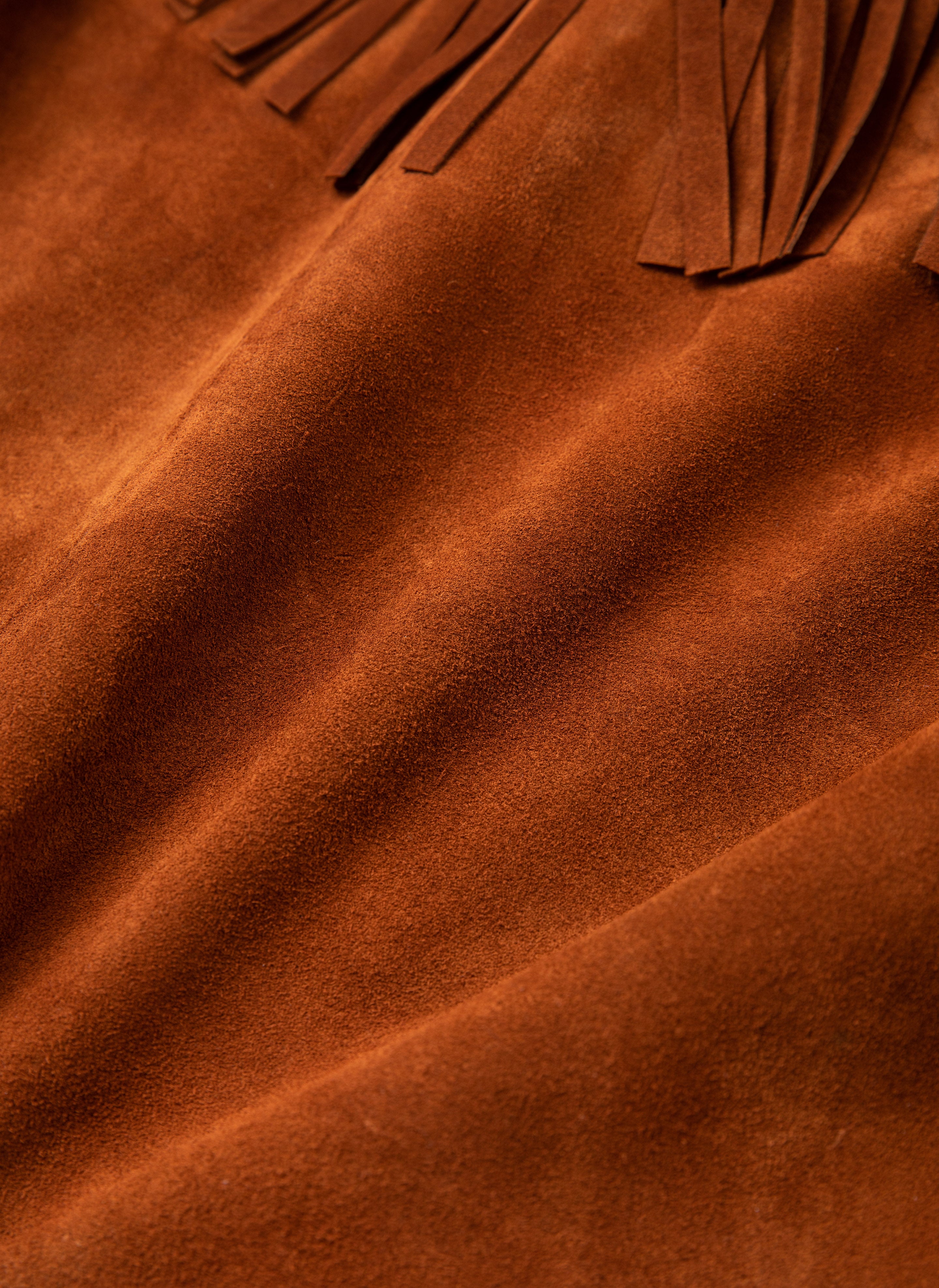 Close-up of the FOUND Western Fringe Suede Jacket, showcasing a two-tone suede and leather material with neat stitching and fringed detailing.