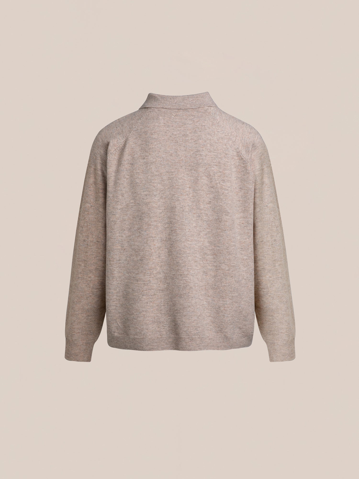 Back view of the Hay Collared Knit Henley by FOUND, a beige long-sleeve sweater with a high collar and raglan sleeves, displayed against a light beige background.