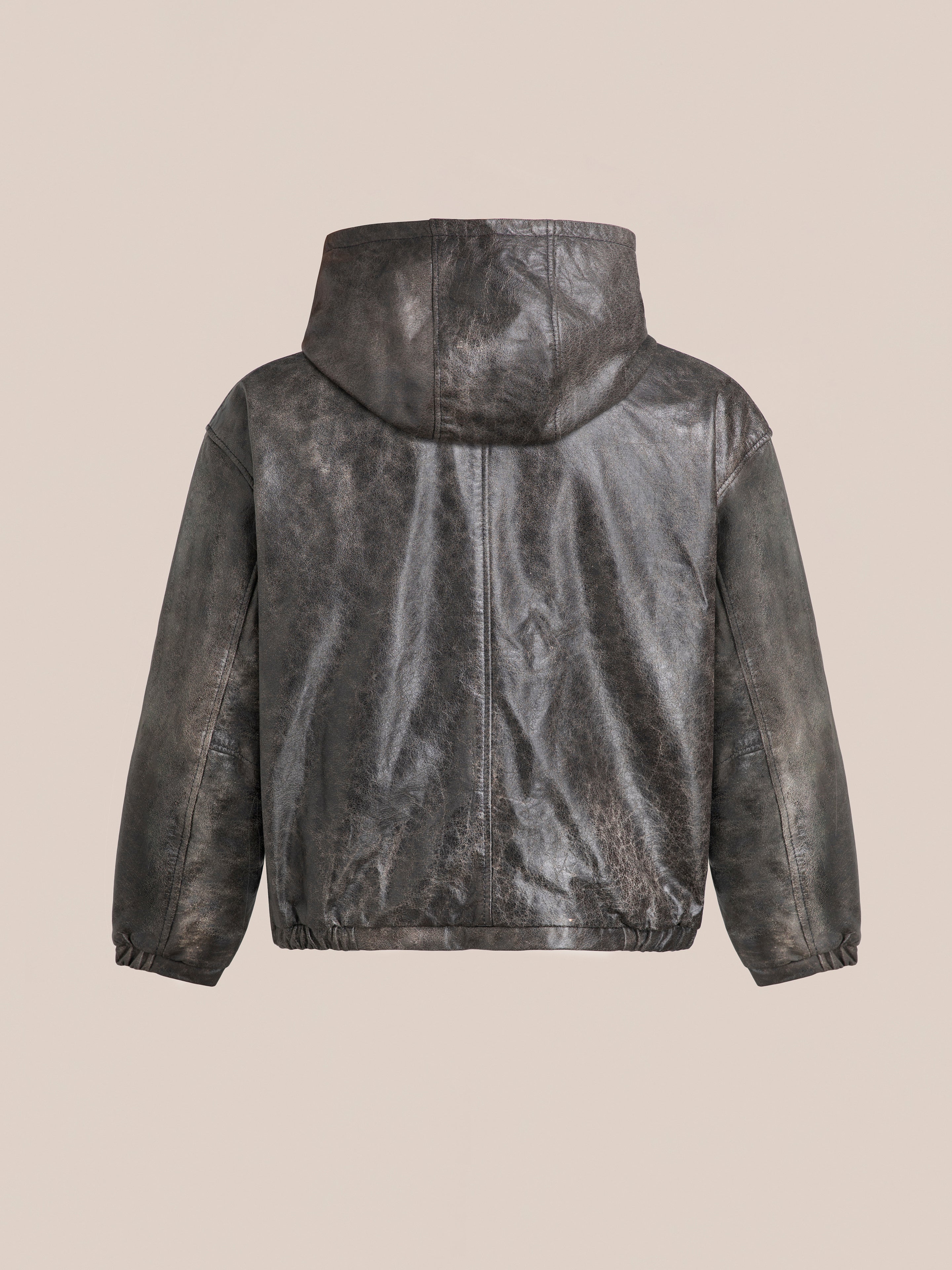 Back view of the Found Distressed Genuine Leather Hoodie with a distressed finish, made from ethically sourced materials, displayed against a plain beige background.