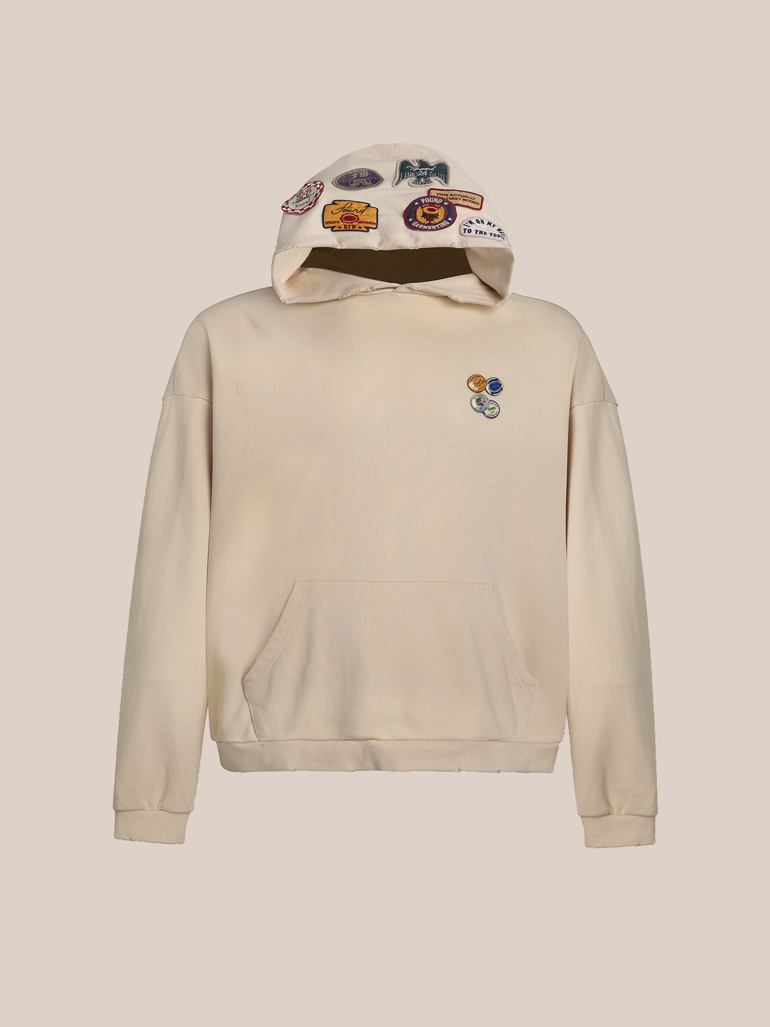 The Faded Patch Hoodie by FOUND, made from cotton French Terry, features a vintage aesthetic with colorful patches on the hood and a small chest patch design. A handy front pocket completes this stylish garment.