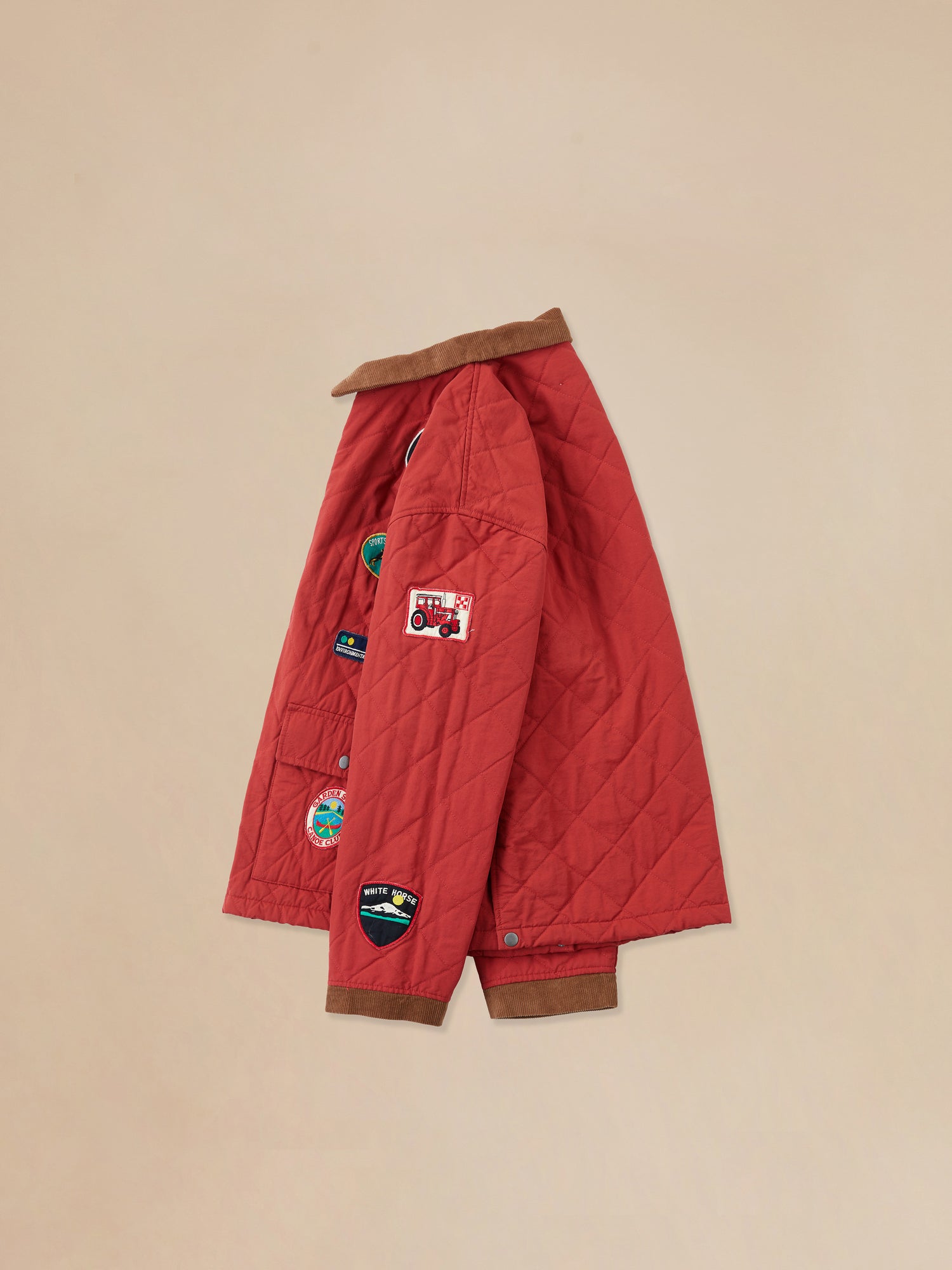 A Farmstead Quilt Patch Jacket by Found, a red quilted jacket with patches on it.