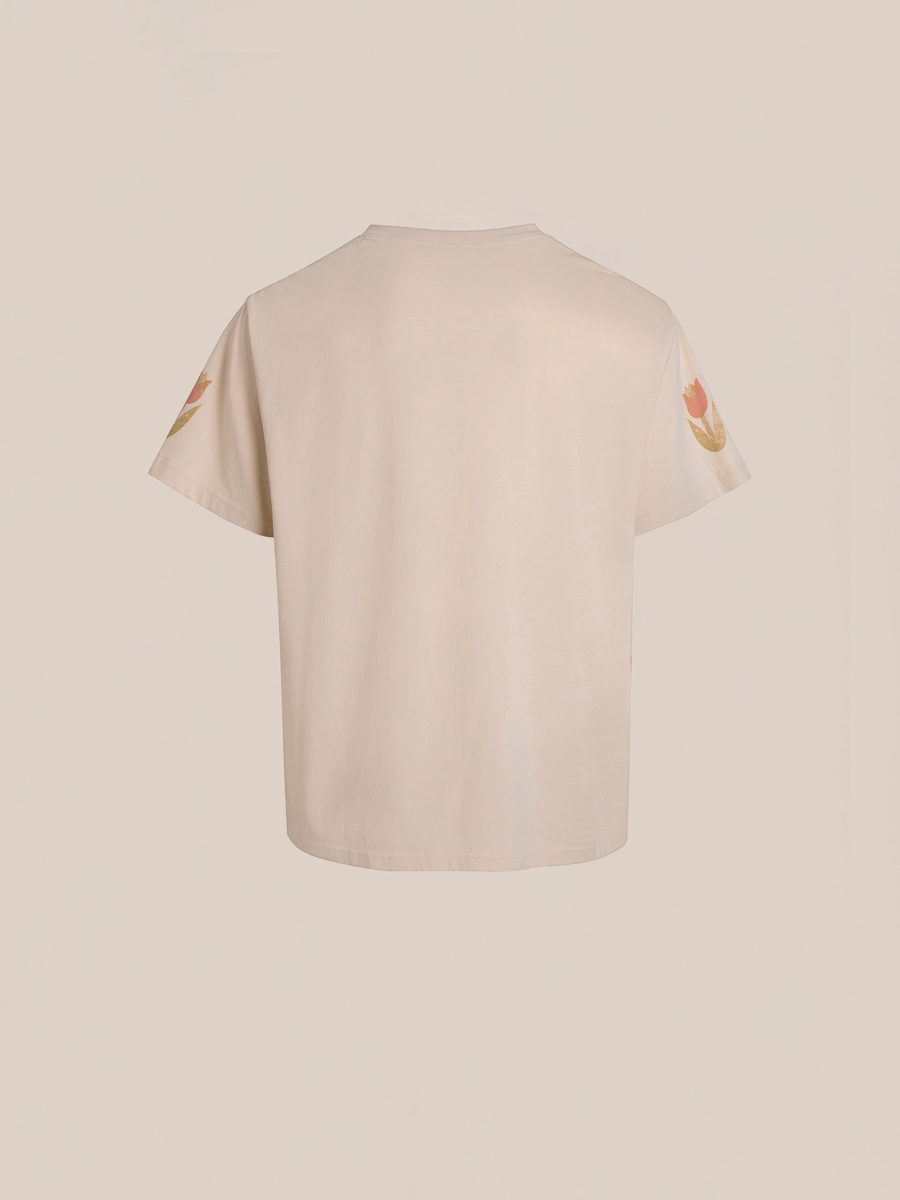 FOUND's Floral Horse Farm Tee is a beige T-shirt with short sleeves and Floral Horse Farm-inspired designs on each upper arm, shown from the back.