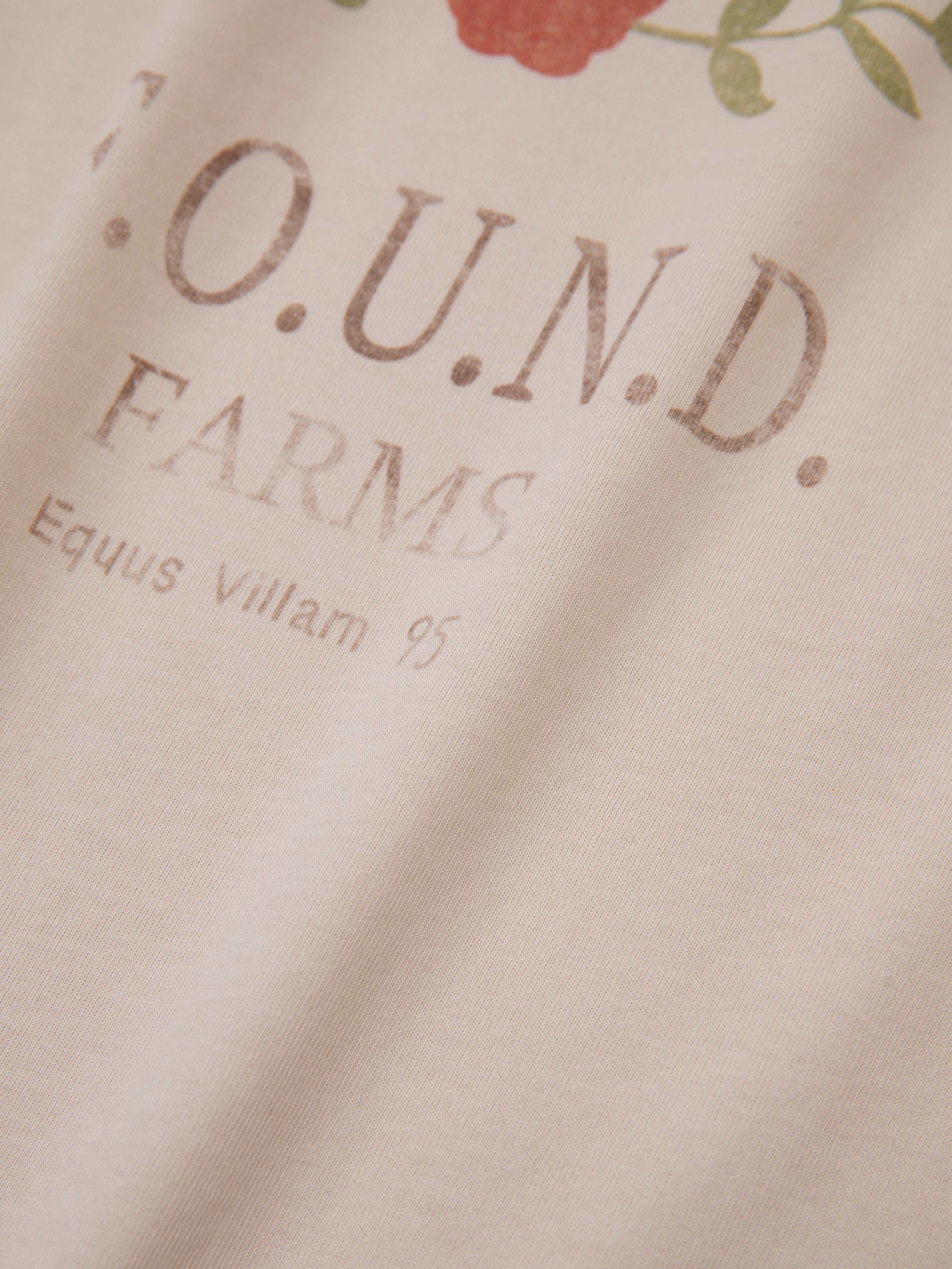 Close-up of fabric displaying "FOUND" and "Equus Villam 95," featuring equestrian graphics and vintage artistry, evoking a Floral Horse Farm Tee.