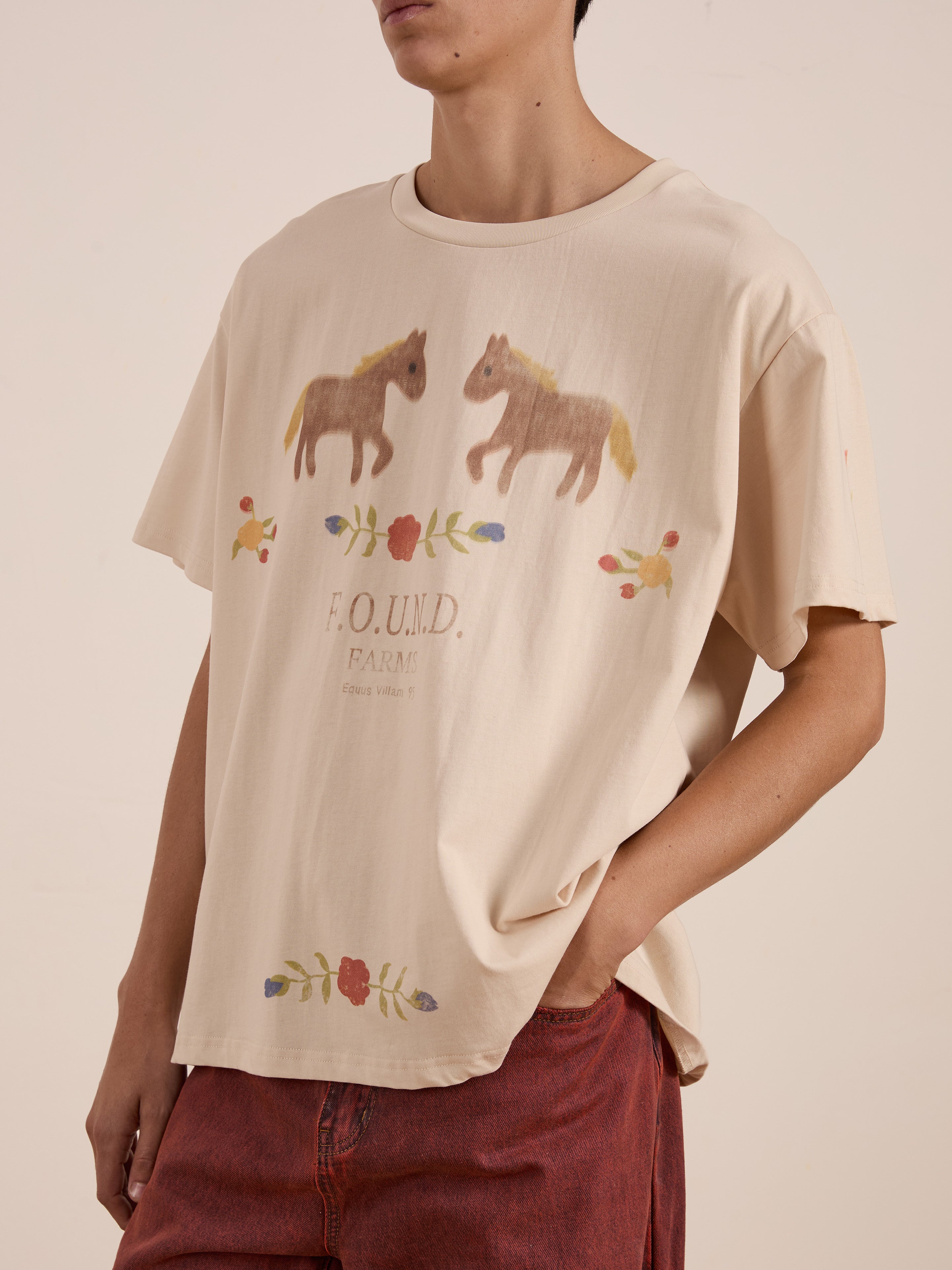 Someone wore the FOUND Floral Horse Farm Tee, featuring equestrian graphics and floral patterns, paired with vibrant red pants.