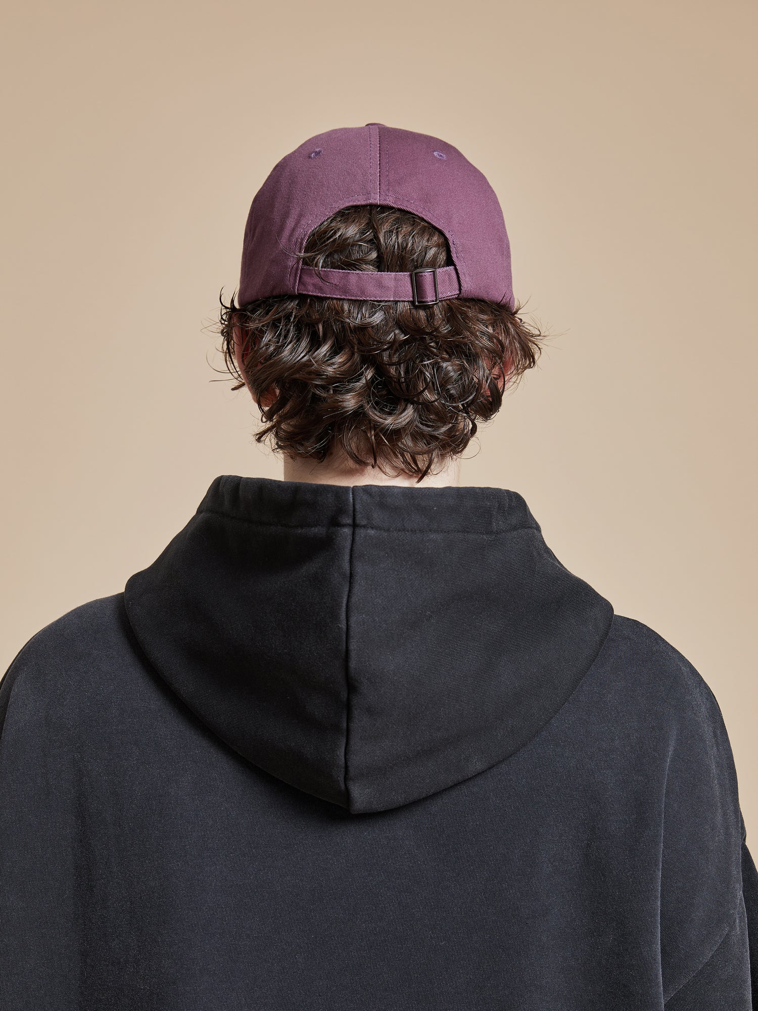 The back view of a man wearing a Found Flower Deer Cap.