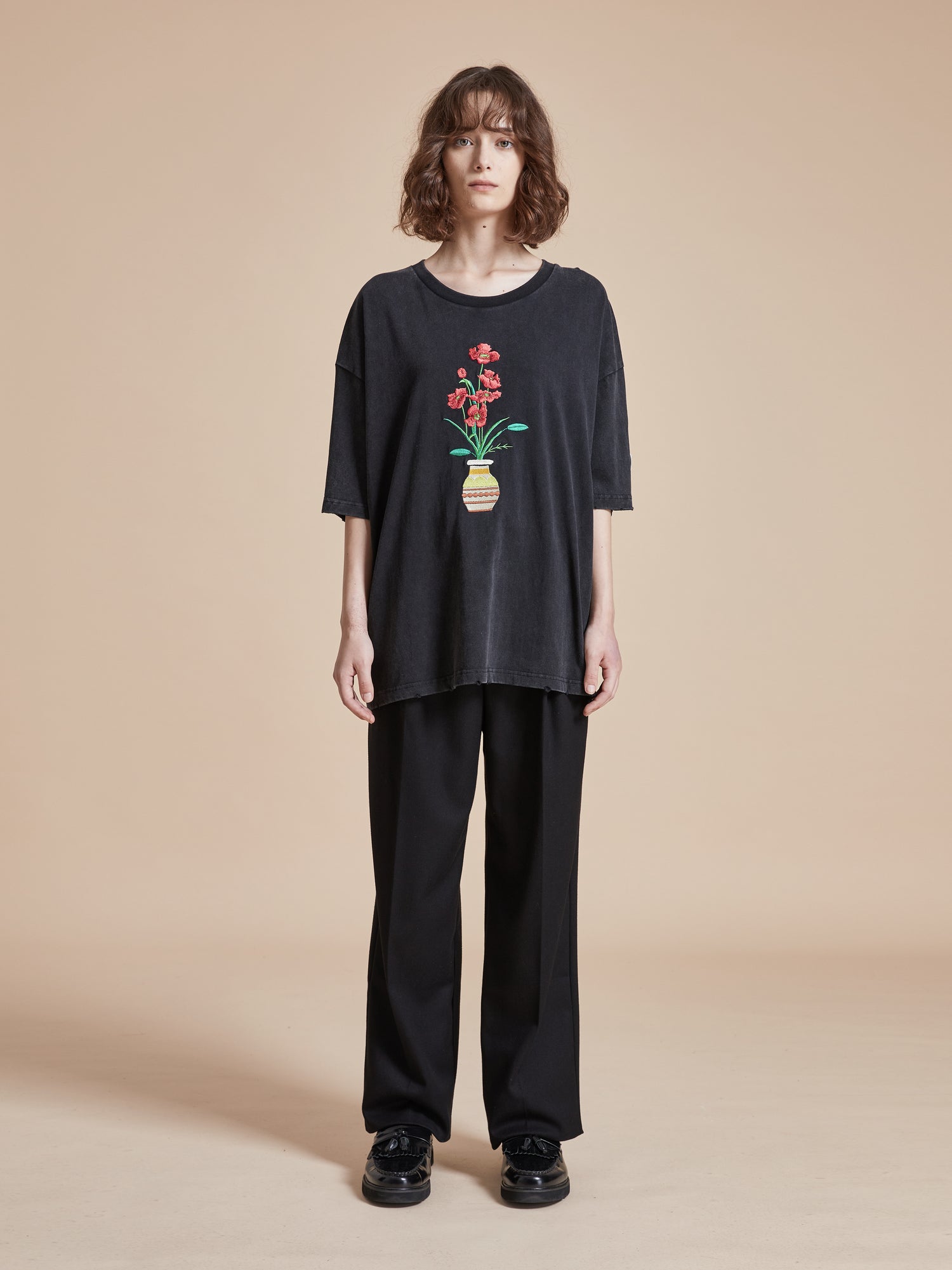 A woman wearing a Found Flowers Vase Tee.