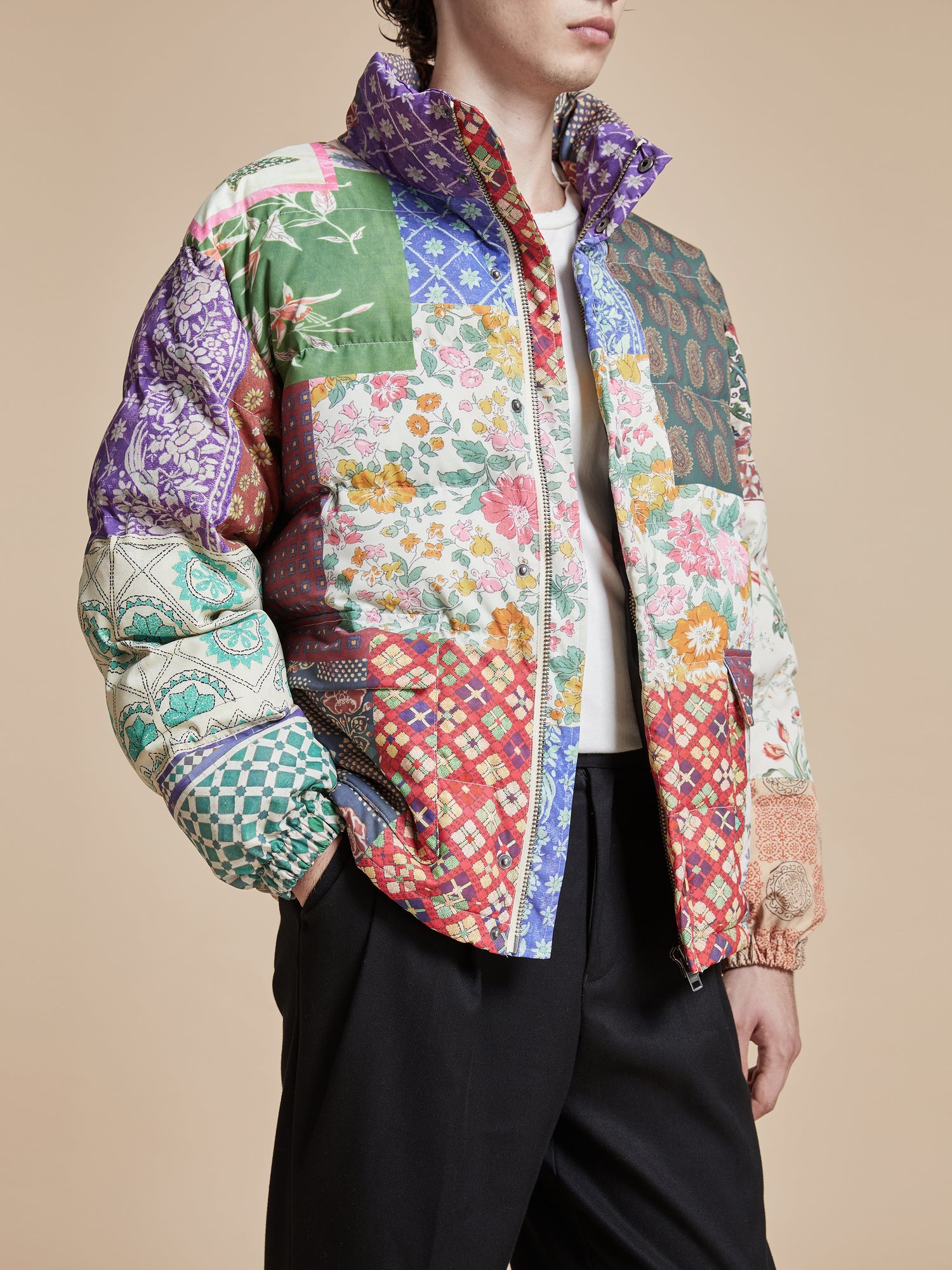 The model is wearing a pre-order Found Gardenia Tapestry Puffer Jacket with a patchwork pattern.