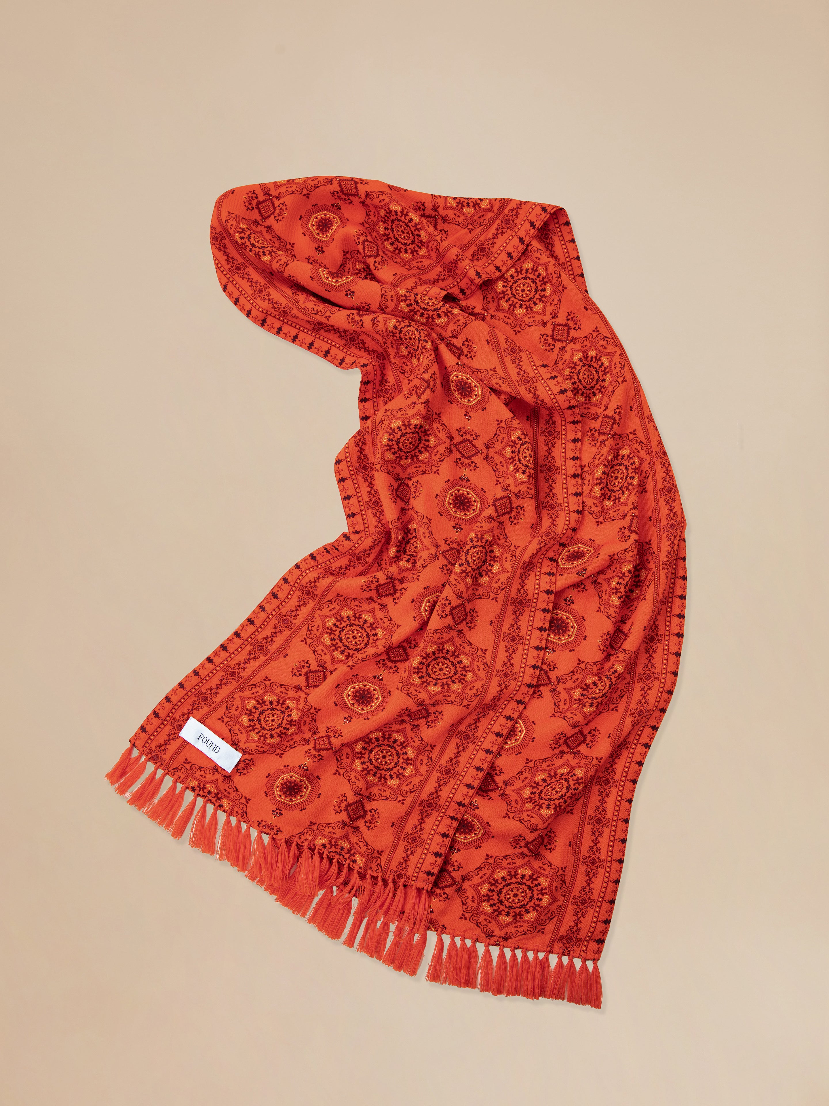 A Found Grenadine scarf with hand tied tassels.