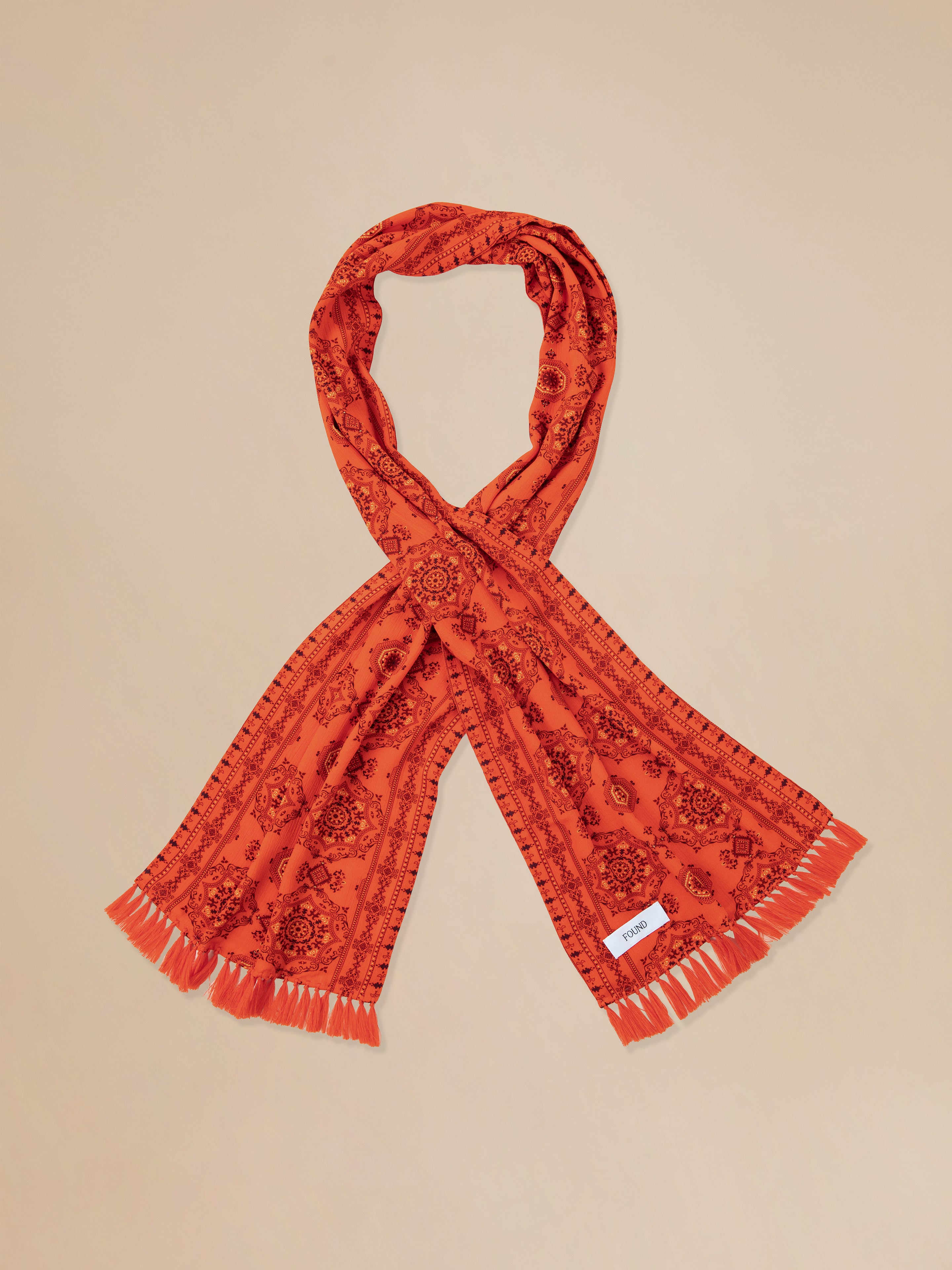 A Found Grenadine scarf with hand tied tassels.