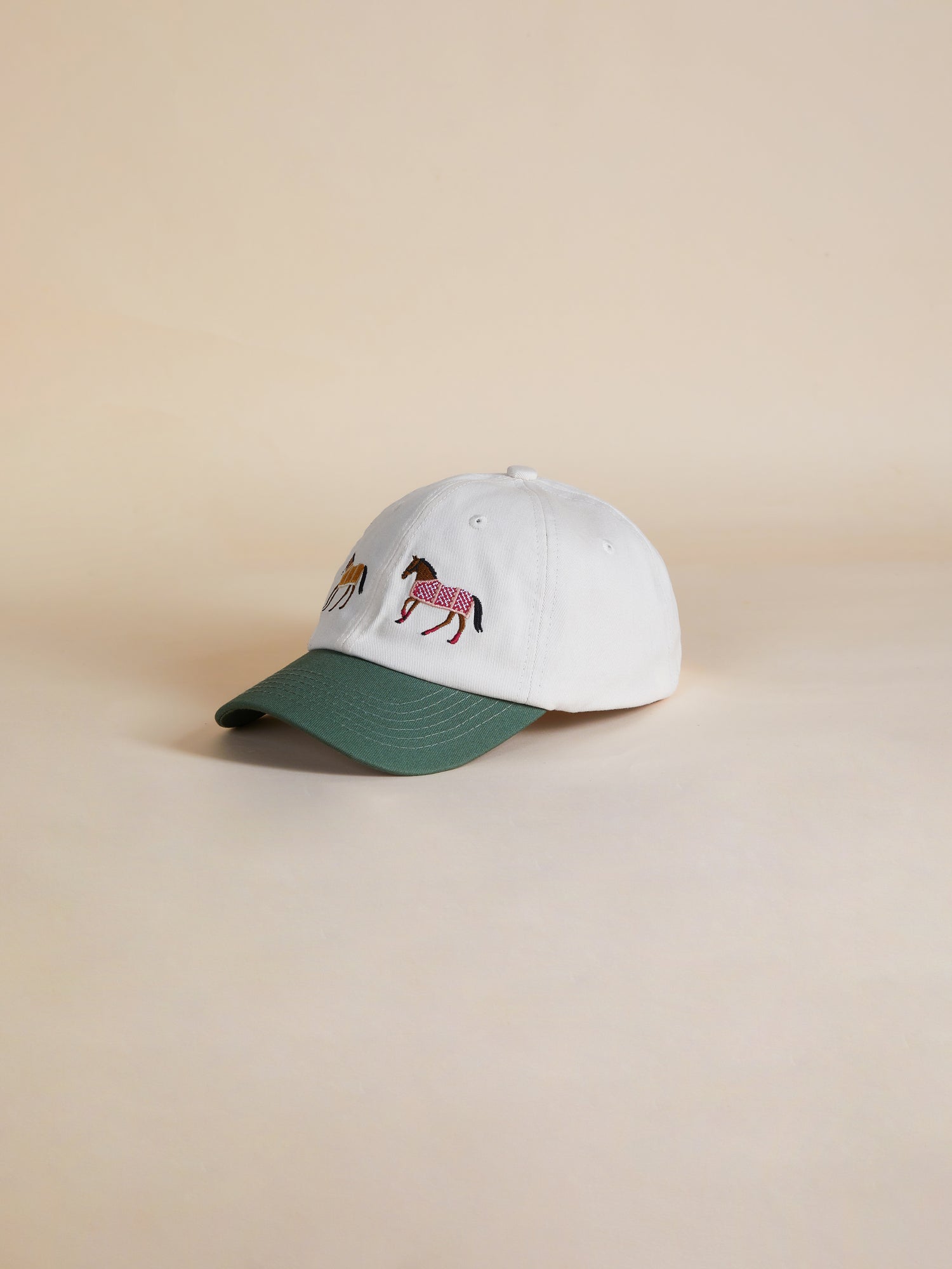 A white Horse Equine Cap with embroidered horses on it by Found.