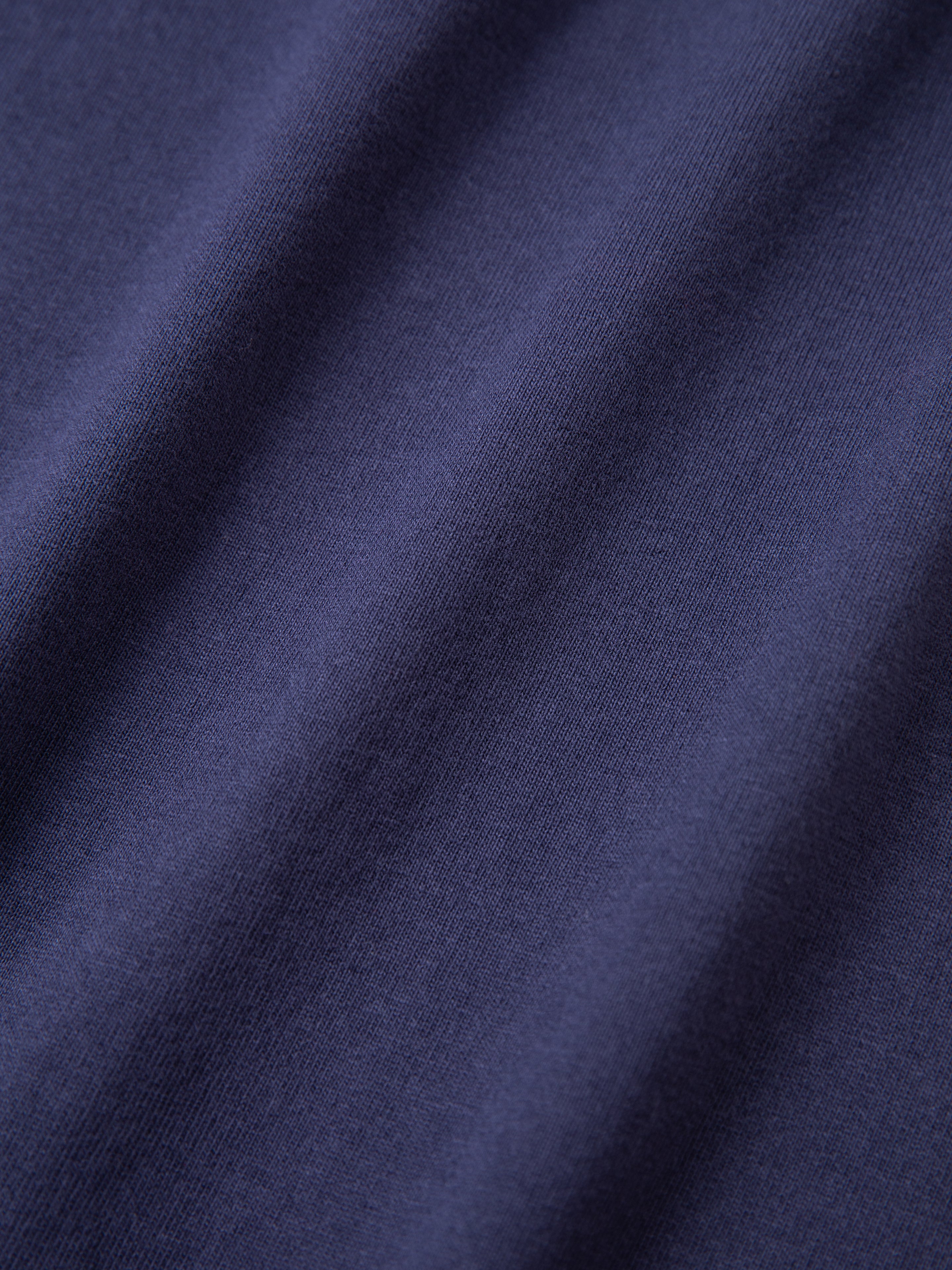 Close-up of the Horse Equine Tee by FOUND, showcasing its dark blue fabric texture and weave.