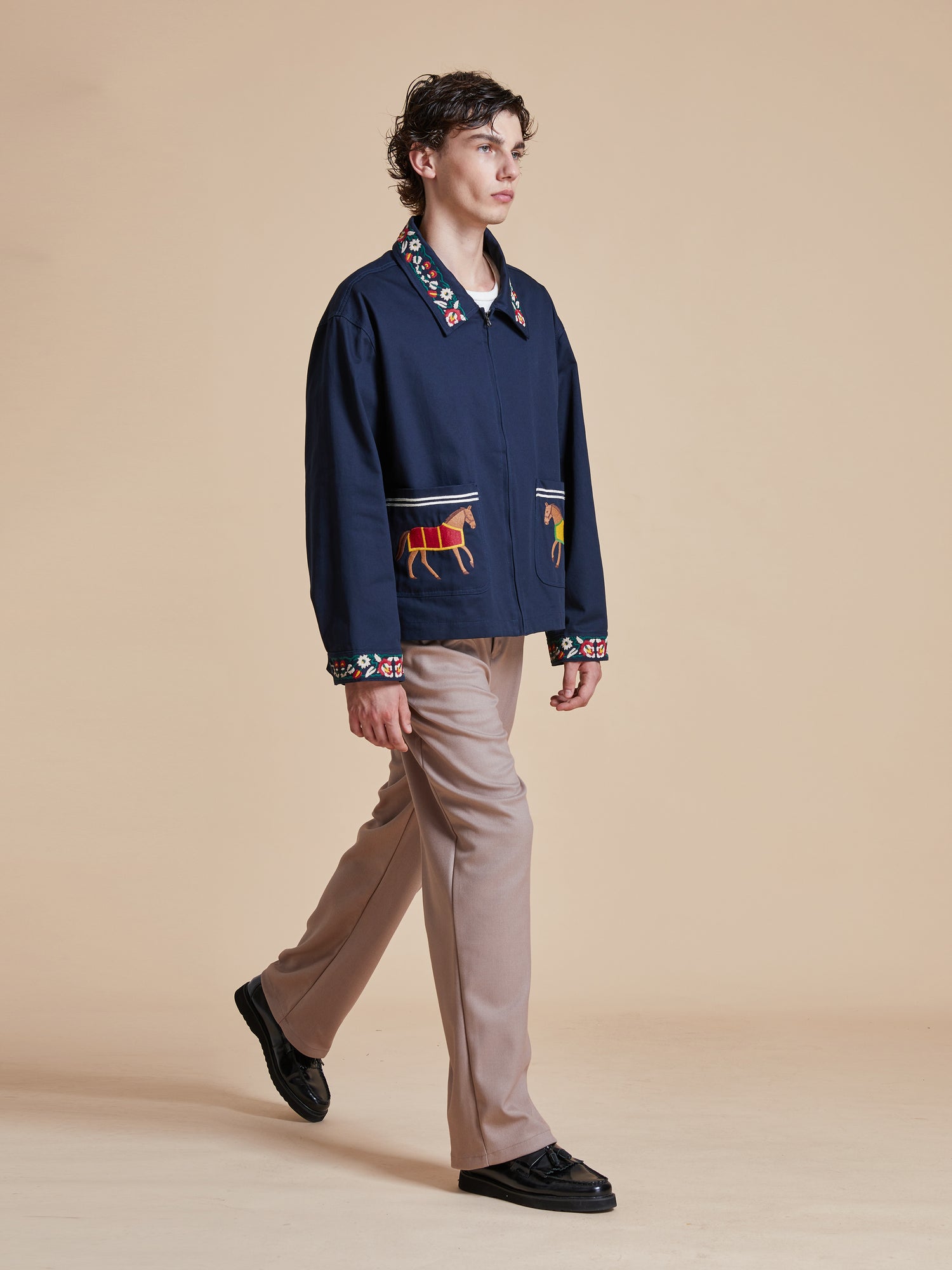 The model is wearing a Found Horse Equine Work Jacket and tan pants.