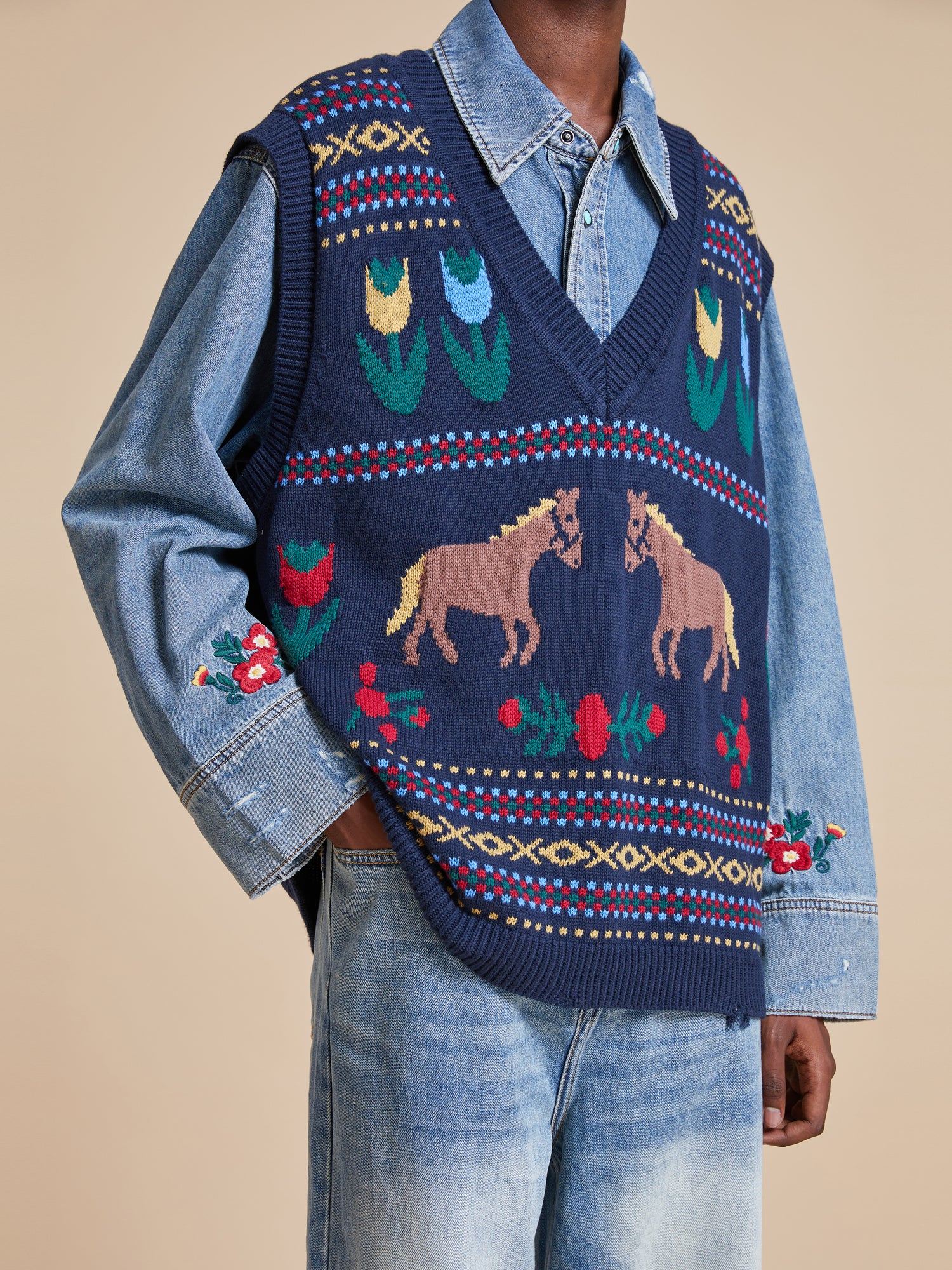 A man wearing a Found Isle Horse Reverie Sweater Knit Vest.