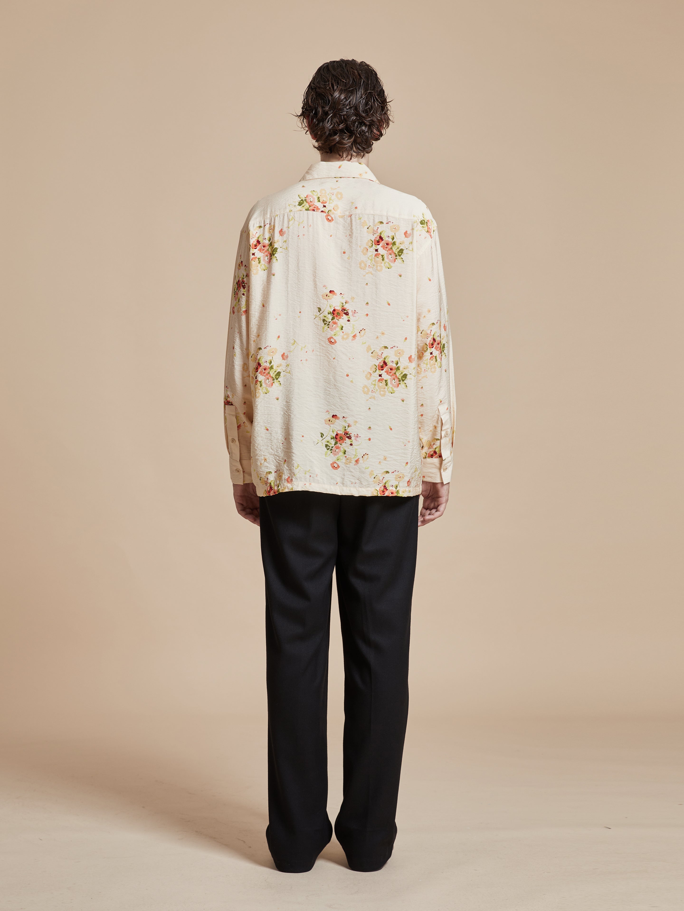 The back of a man wearing a Found Kanhati Garden Long Sleeve Camp Shirt.