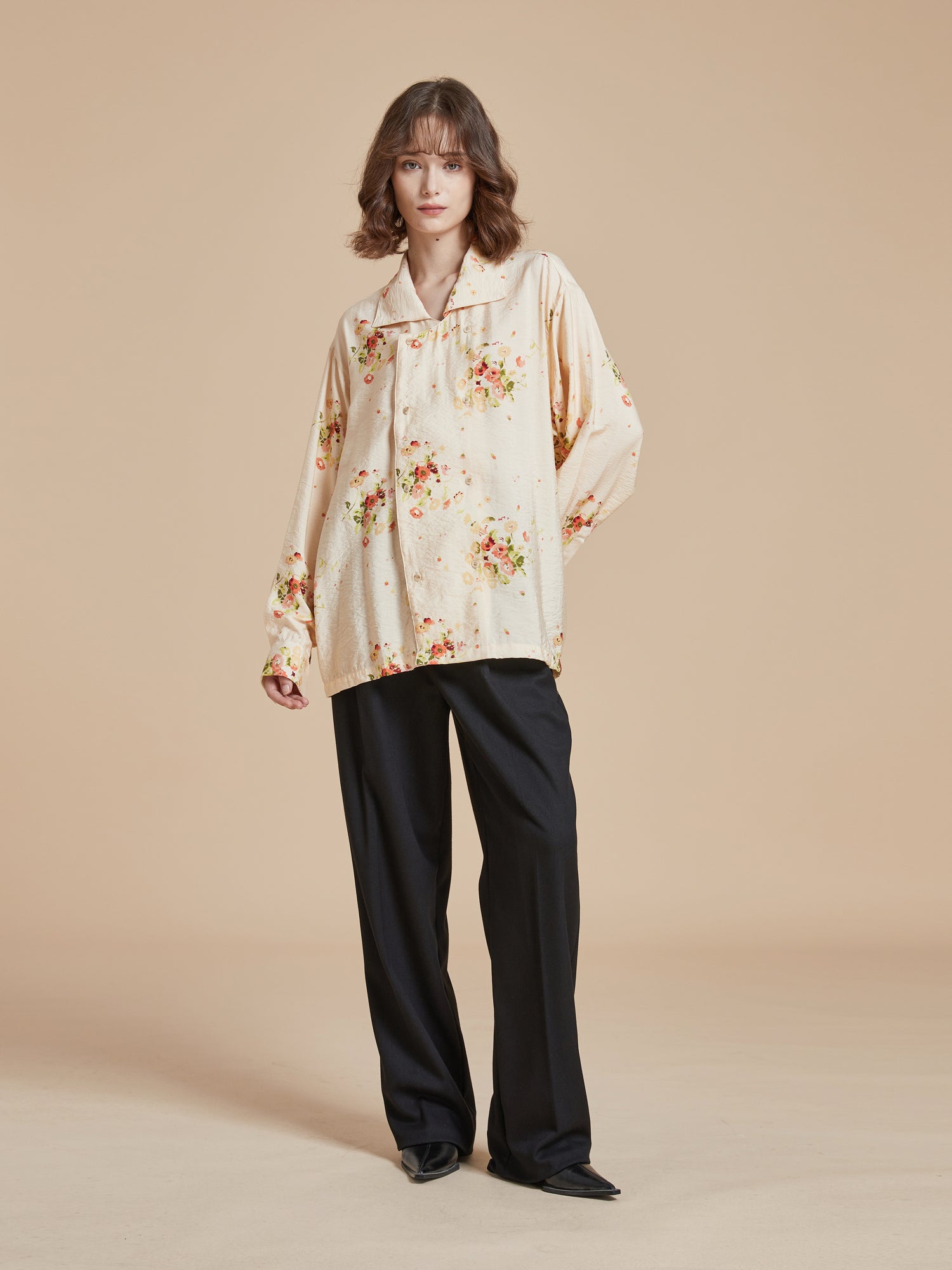 The model is wearing a Found Kanhati Garden Long Sleeve Camp Shirt with a floral print.