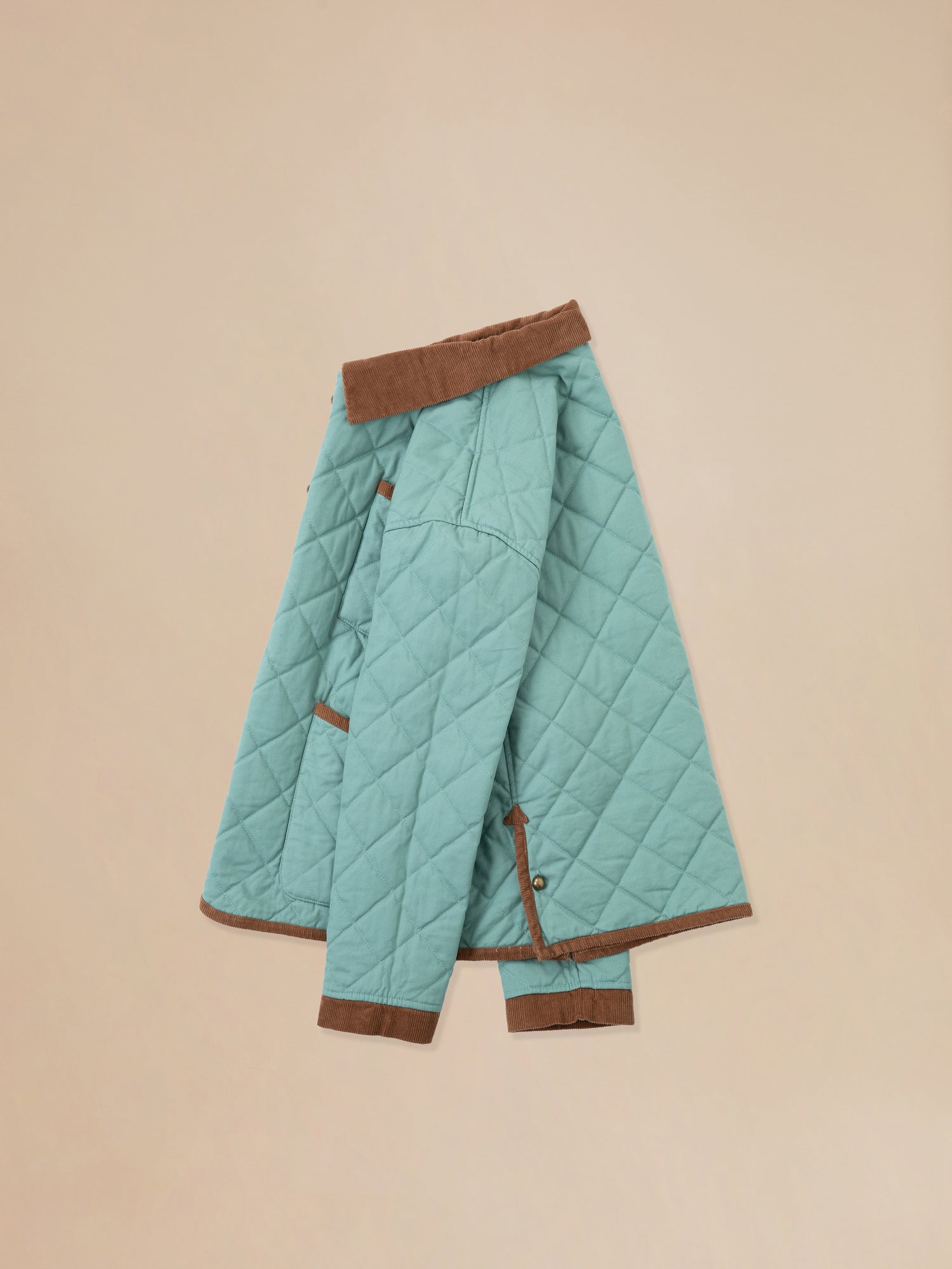 A Kashmir Meadow Quilt Jacket with brown trim by Found.
