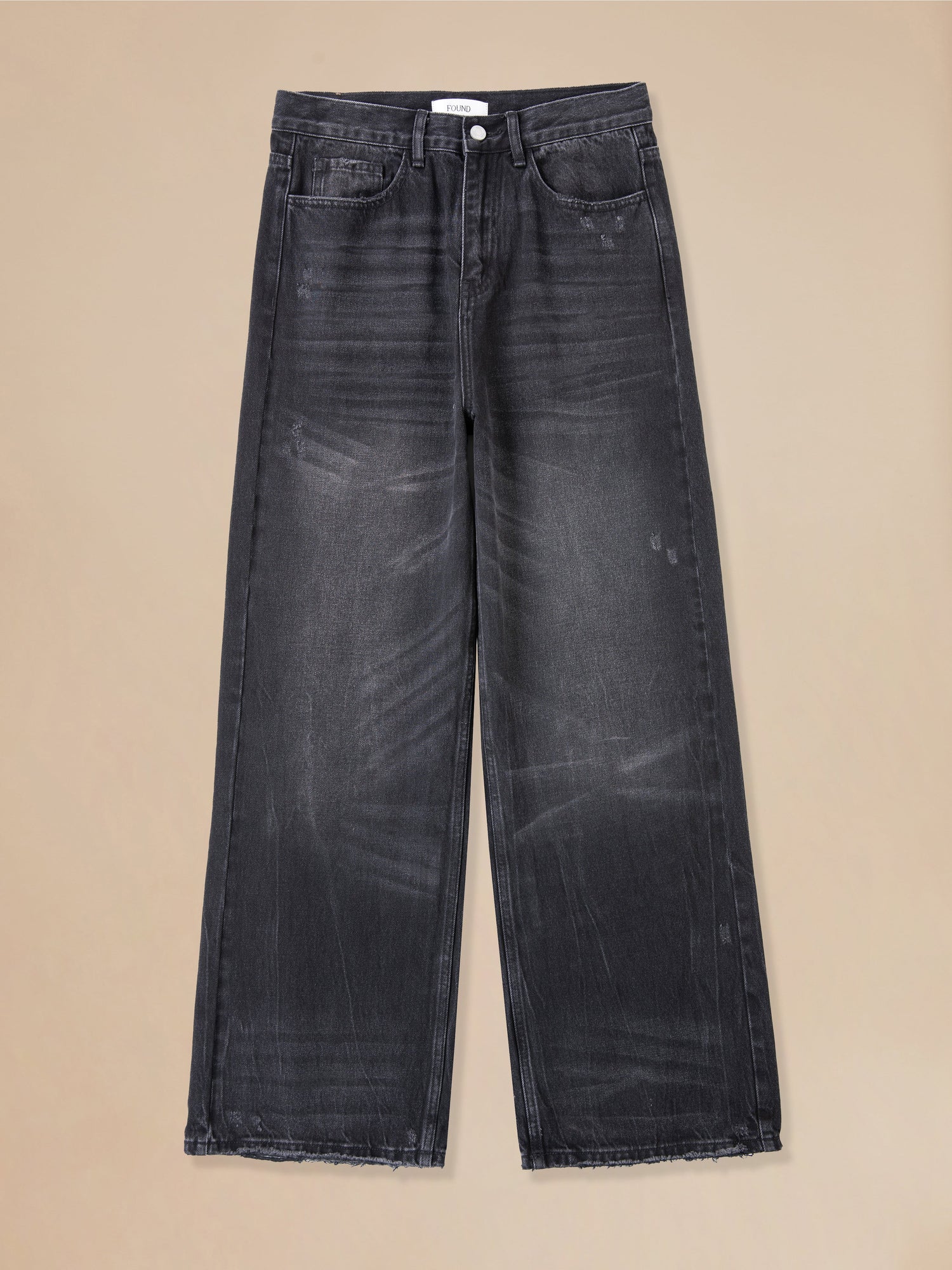 A pair of Found Lacy Baggy Jeans Vintage Black with distressed hems.
