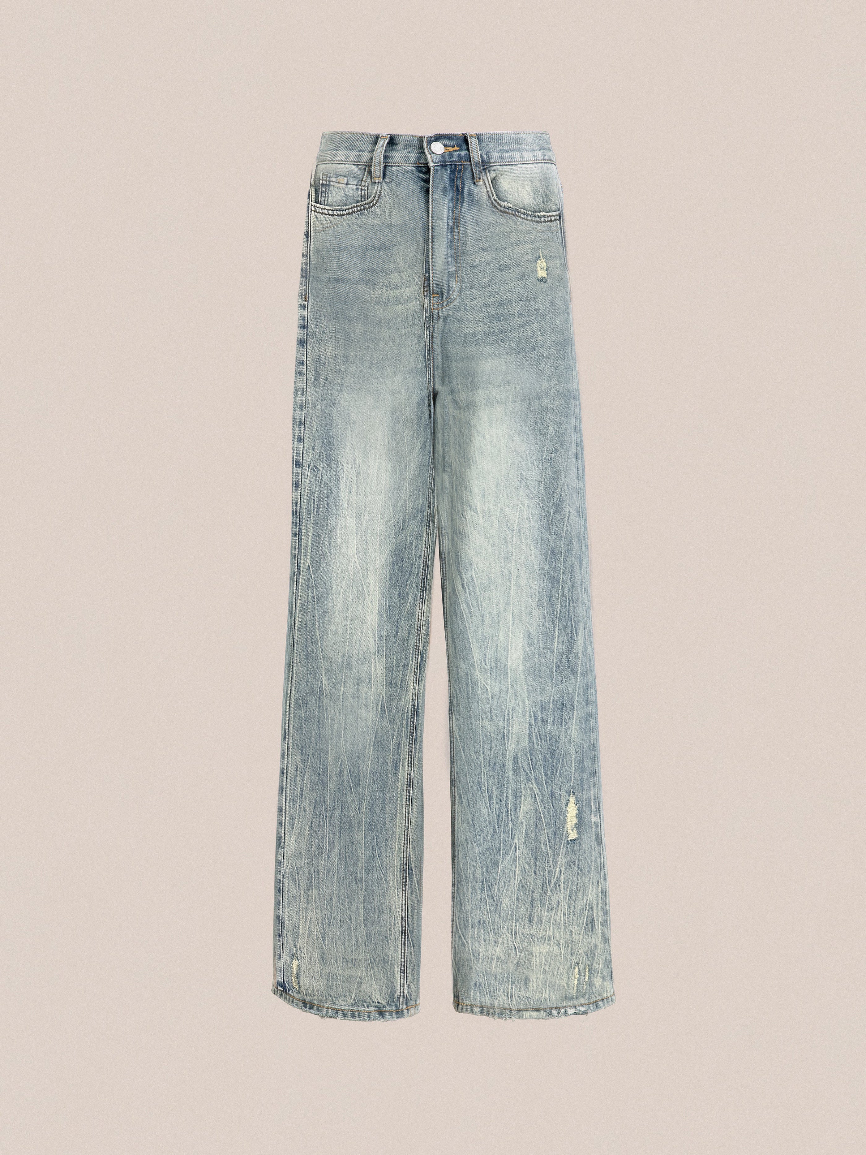 The Lacy Baggy Jeans by Found are wide-leg light blue denim jeans featuring a high waist, distressed details on the left thigh and near the pocket, and frayed hems for an added touch of style.