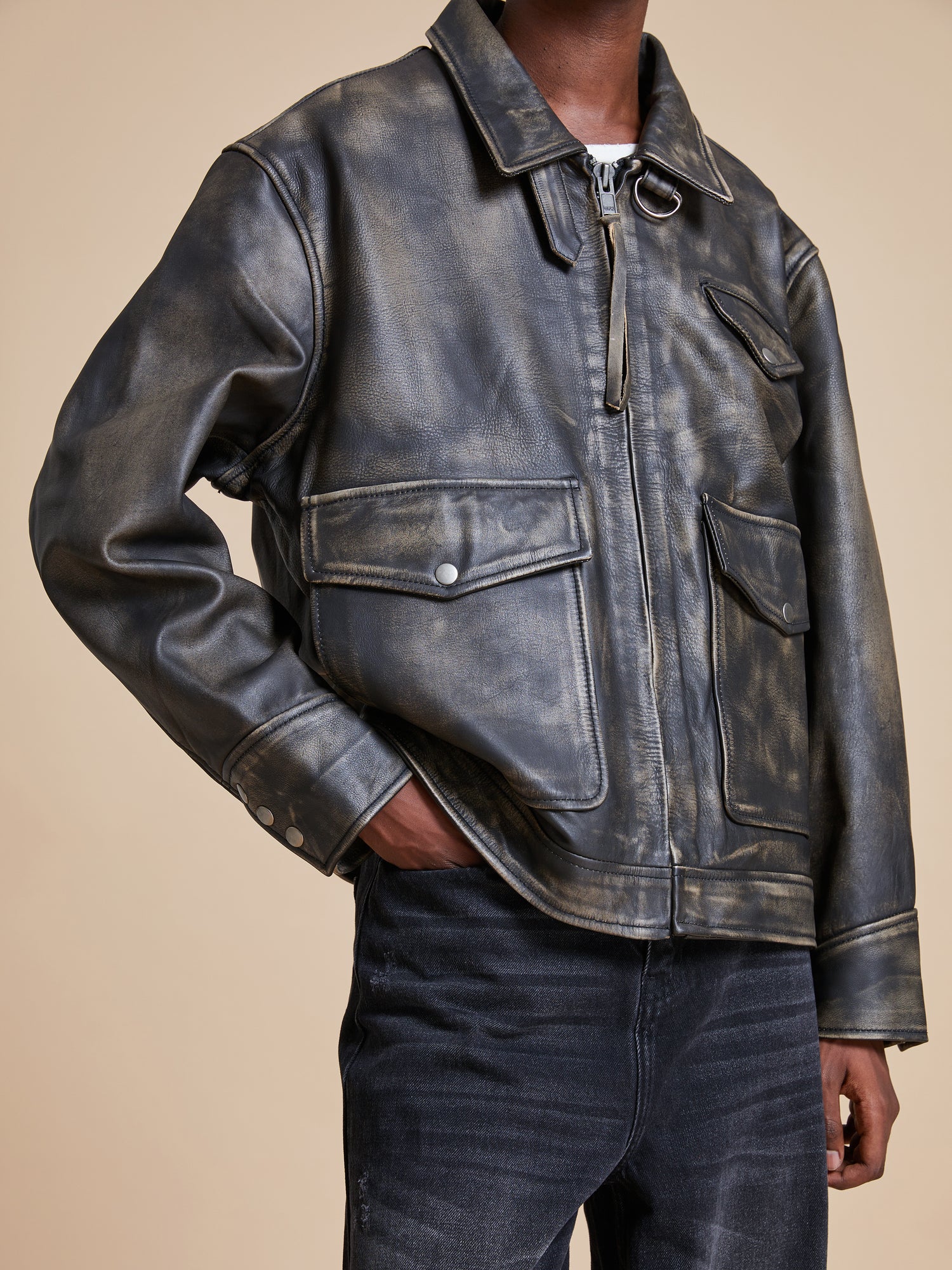 The man is wearing a Found Distressed Leather Pocket Jacket.
