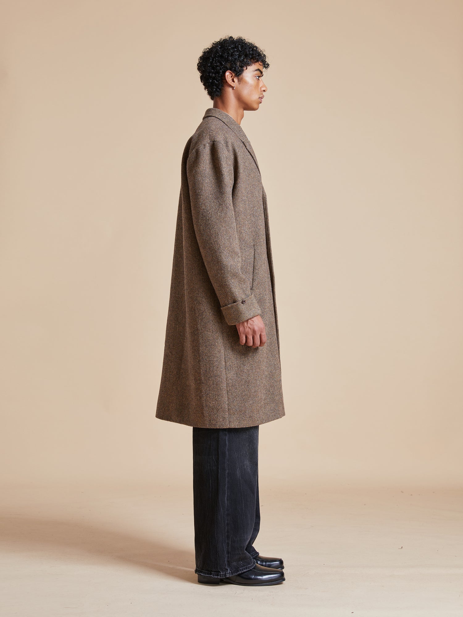 The back view of a man wearing a Found Elm Tweed Long Top Coat.