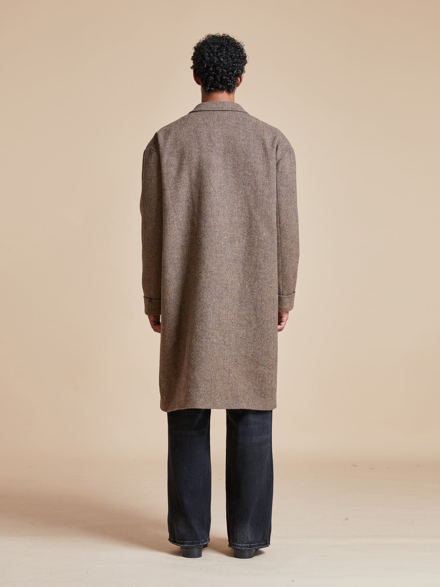 The back view of a man wearing a Found Elm Tweed Long Top Coat.