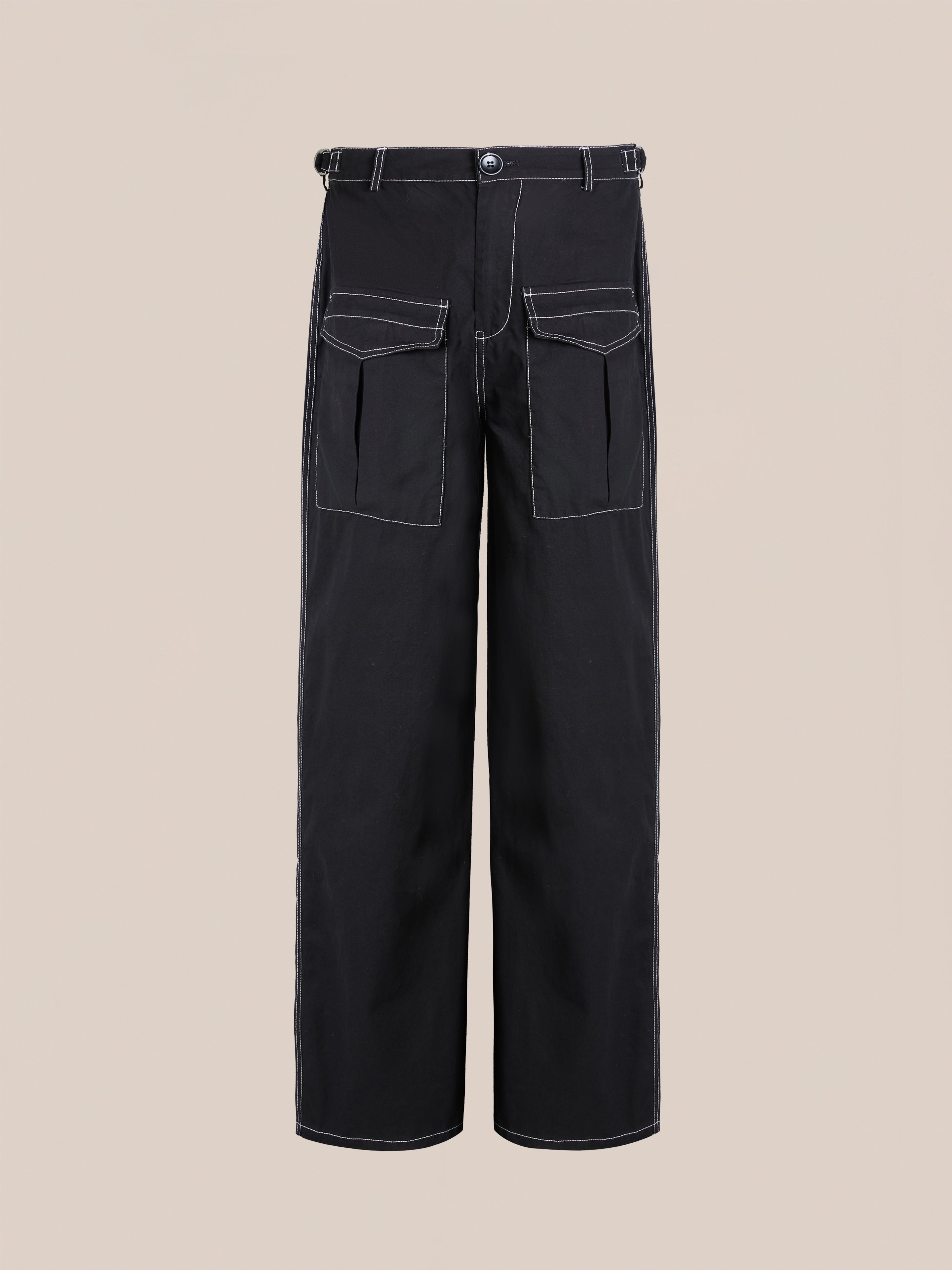 FOUND's Lucca Black Contrast Pocket Pants feature white stitching, two flap-front pockets, a button closure, and are set against a plain beige background. These utility trousers offer a relaxed, straight-leg fit for casual comfort and style.