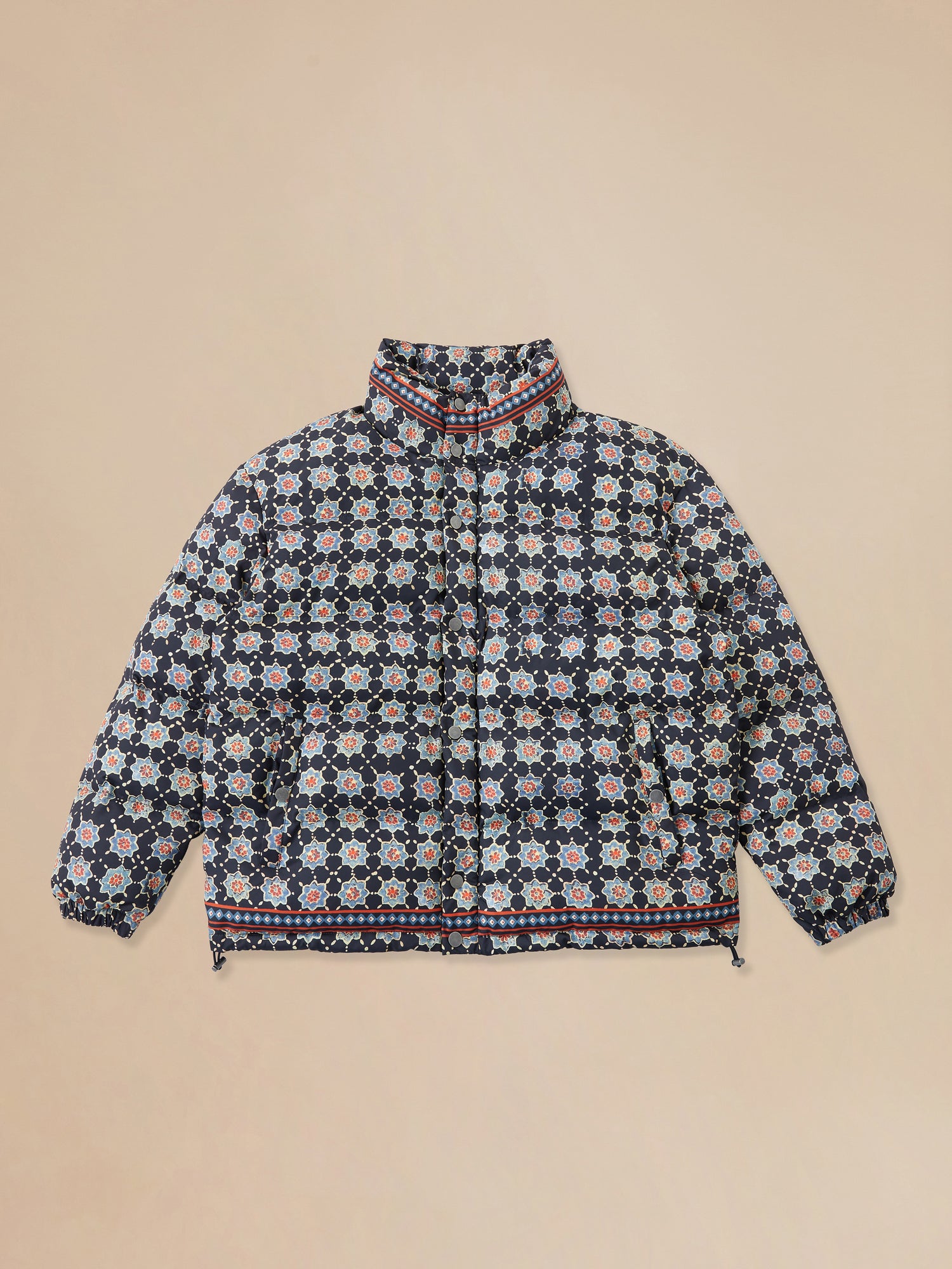 A blue and white Found Ajrak Block Puffer Jacket with a floral pattern, available as a pre-order item.