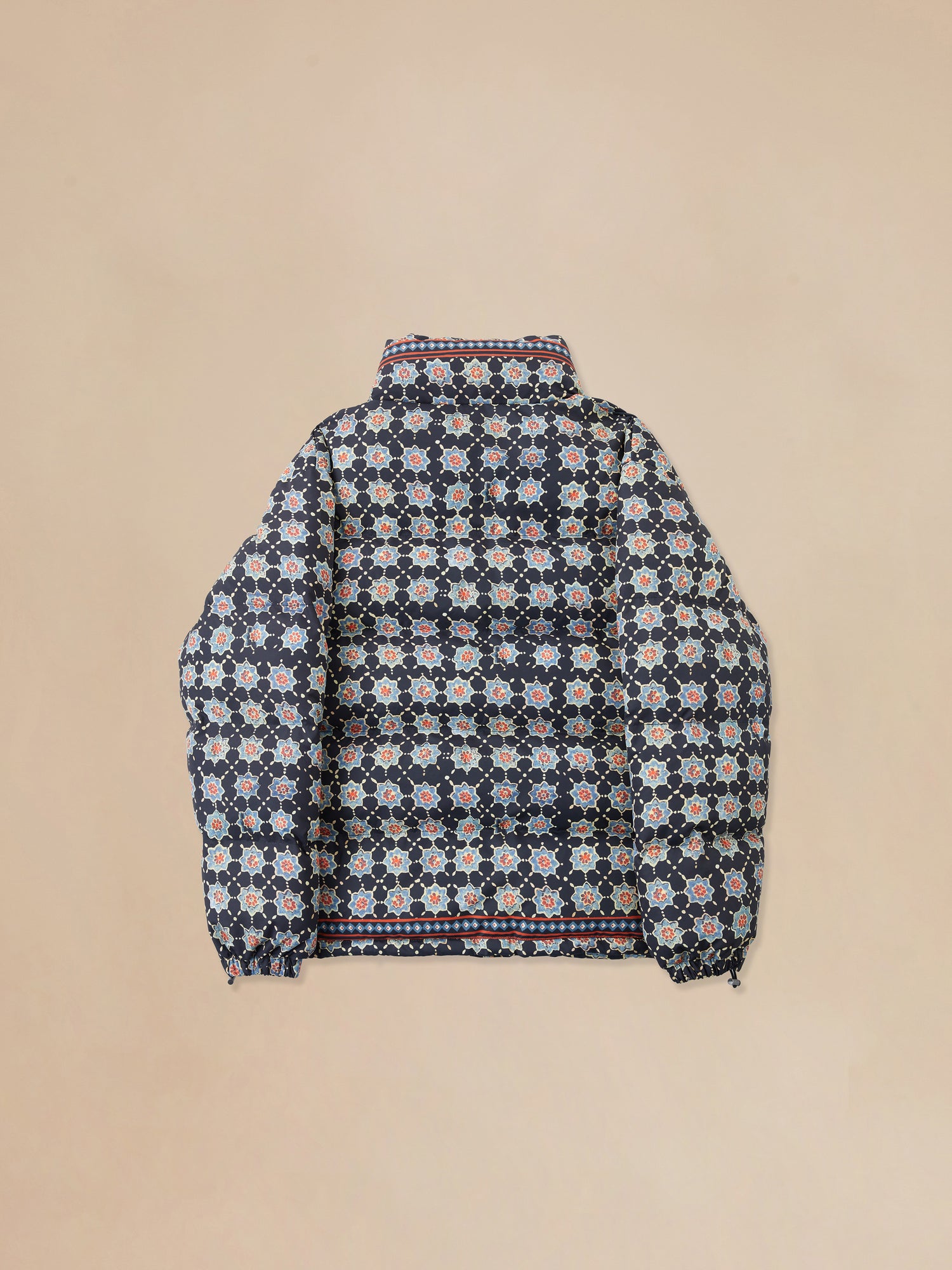 A Ajrak Block Puffer Jacket by Found with Pakistani block-printed patterns on the back.