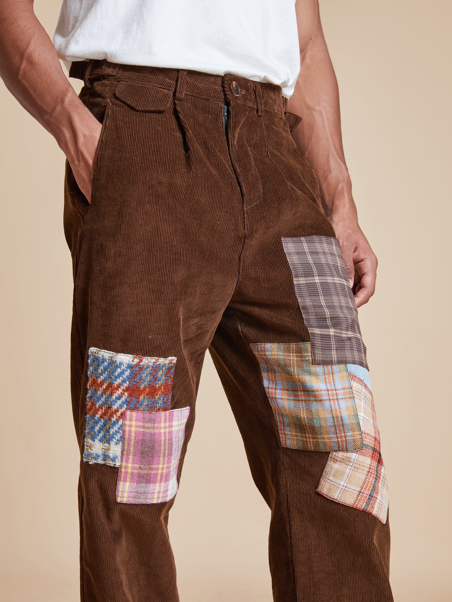 A man wearing Found Multi-Plaid Patch Corduroy Pants.