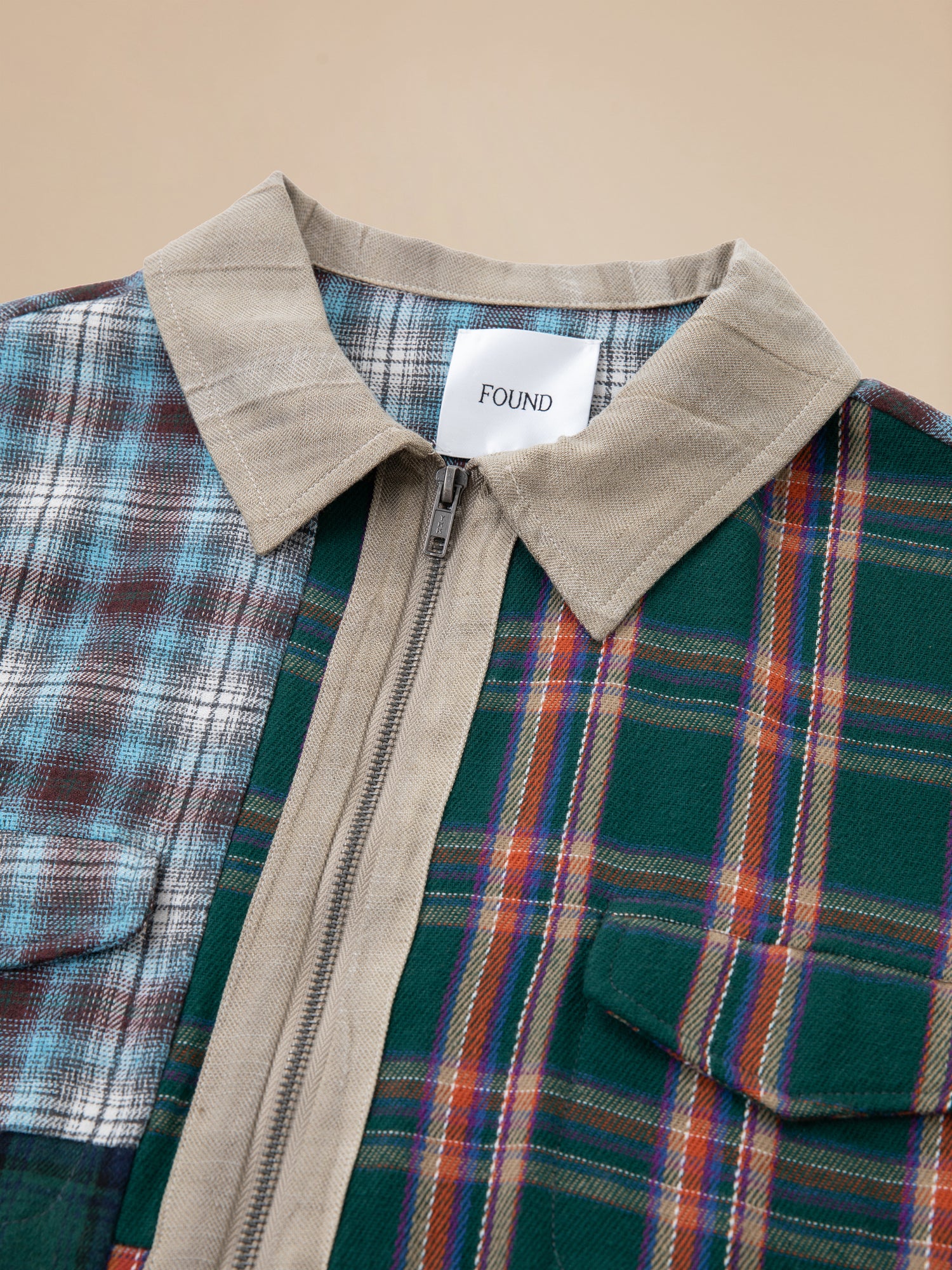 A Multi Plaid Tartan Shirt from Found with a zipper on the front.