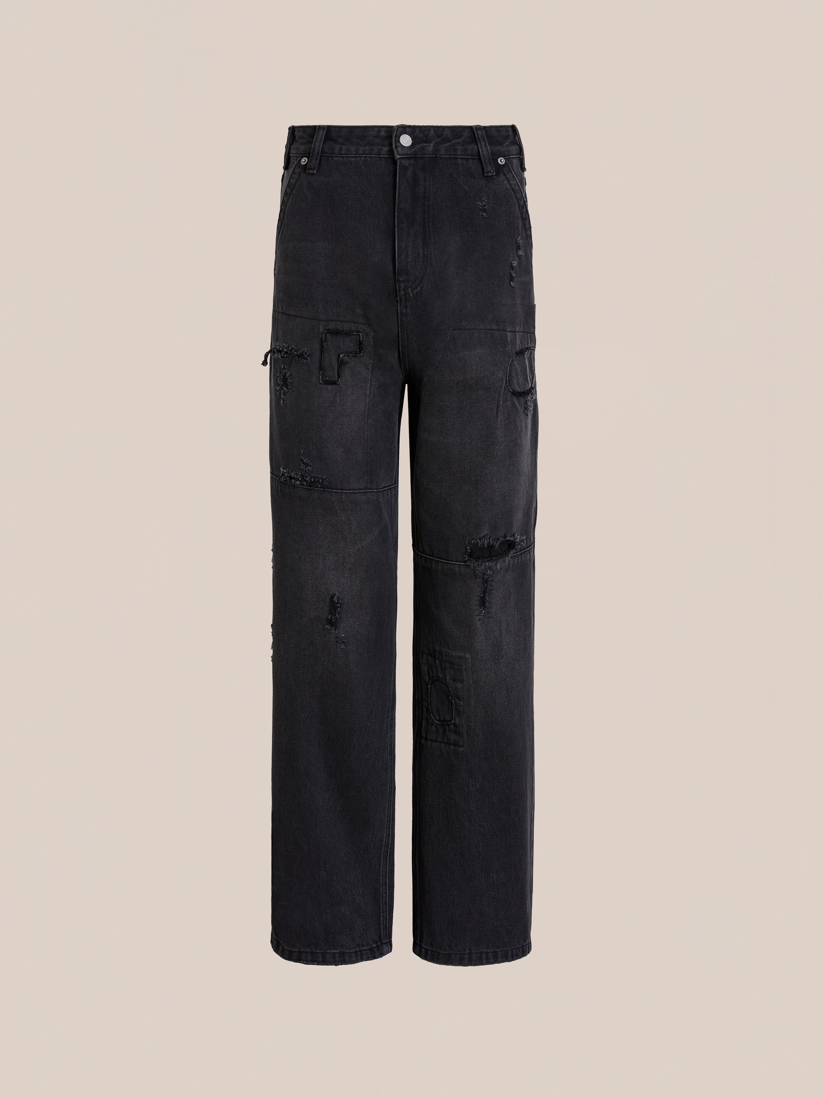 The FOUND Painter Repaired Jeans are black, high-waisted patchwork jeans with wide legs, distressed details, and painter-repaired accents, shown against a plain beige background.
