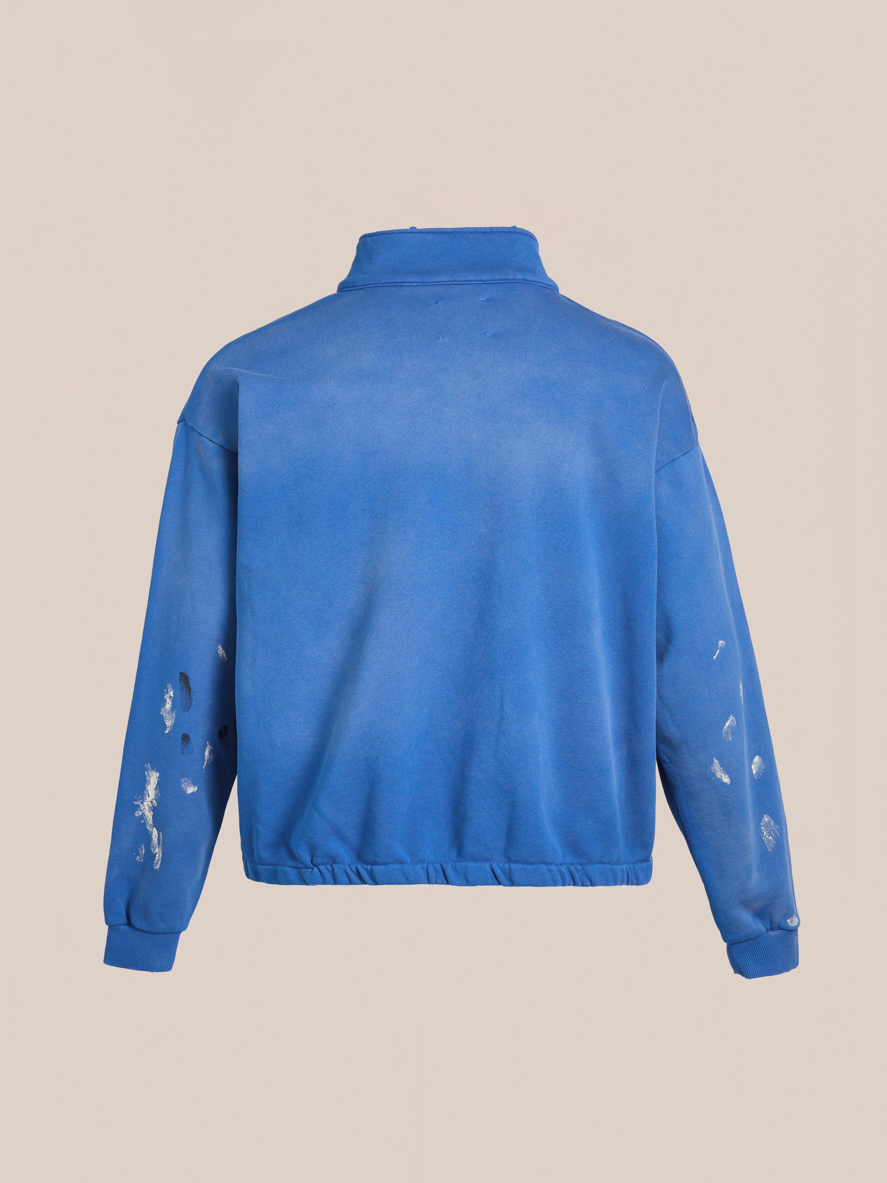 The FOUND Painters Pullover Sweatshirt is a unisex blue zip-up featuring distressed and torn details on the sleeves and back, delivering a rugged workwear vibe when viewed from behind.