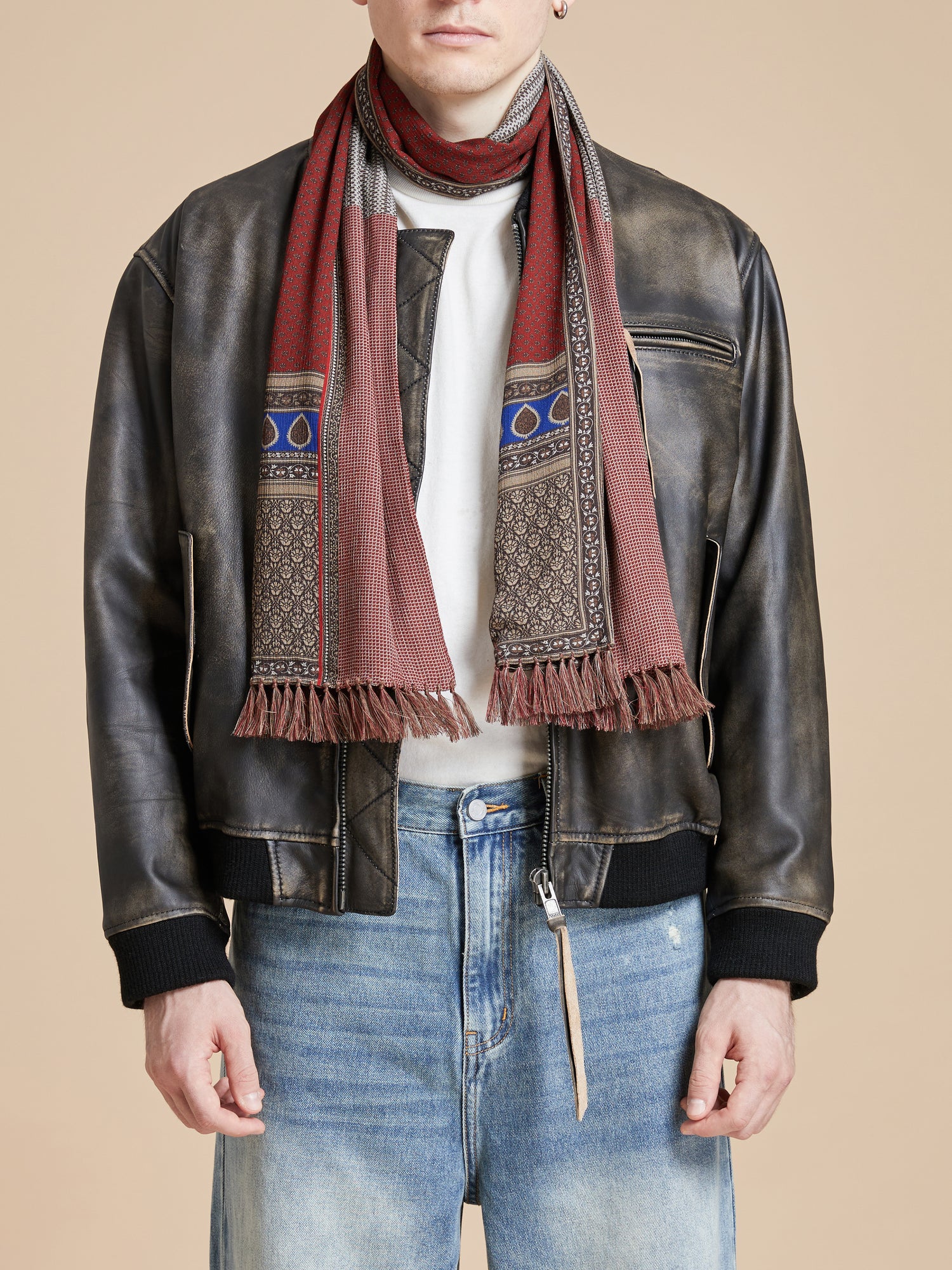 A man in a leather jacket is wearing the Found Paisley Medley Scarf.